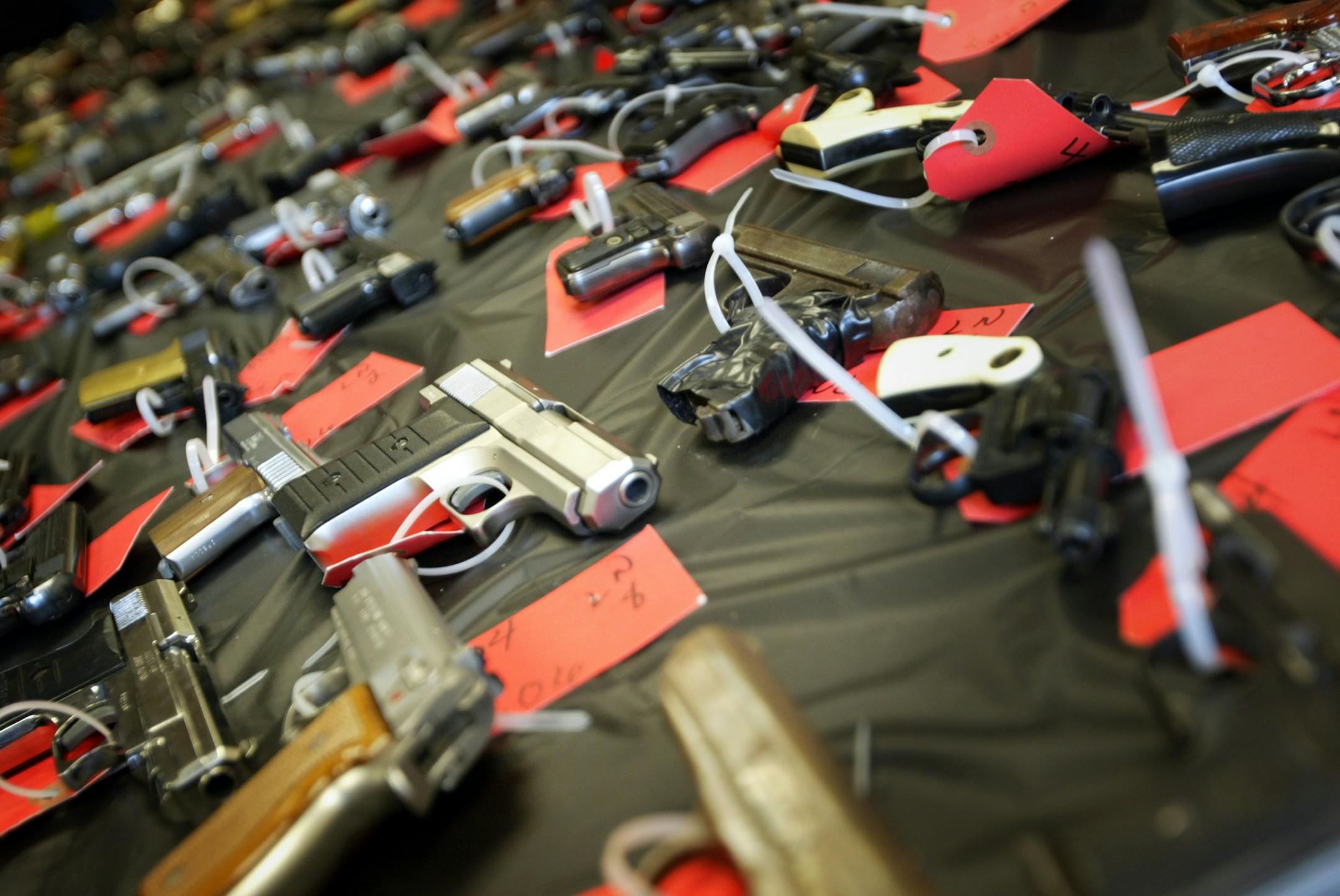RENEE JONES SCHNEIDER Ô reneejones@startribune.com 2/7/06 A table filled with guns is displayed at a recent press conference at the city council office. These guns are some of the more than 200 guns the program Cease Fire collected in a two day period in Minneapolis by offering the public money to turn in their weapons to help fight crime.
