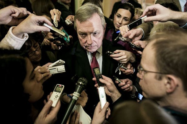 Sen. Dick Durbin (D-Ill.) is questioned by reporters outside a closed fiscal meeting at the U.S. Capitol in Washington, Dec. 30, 2012.