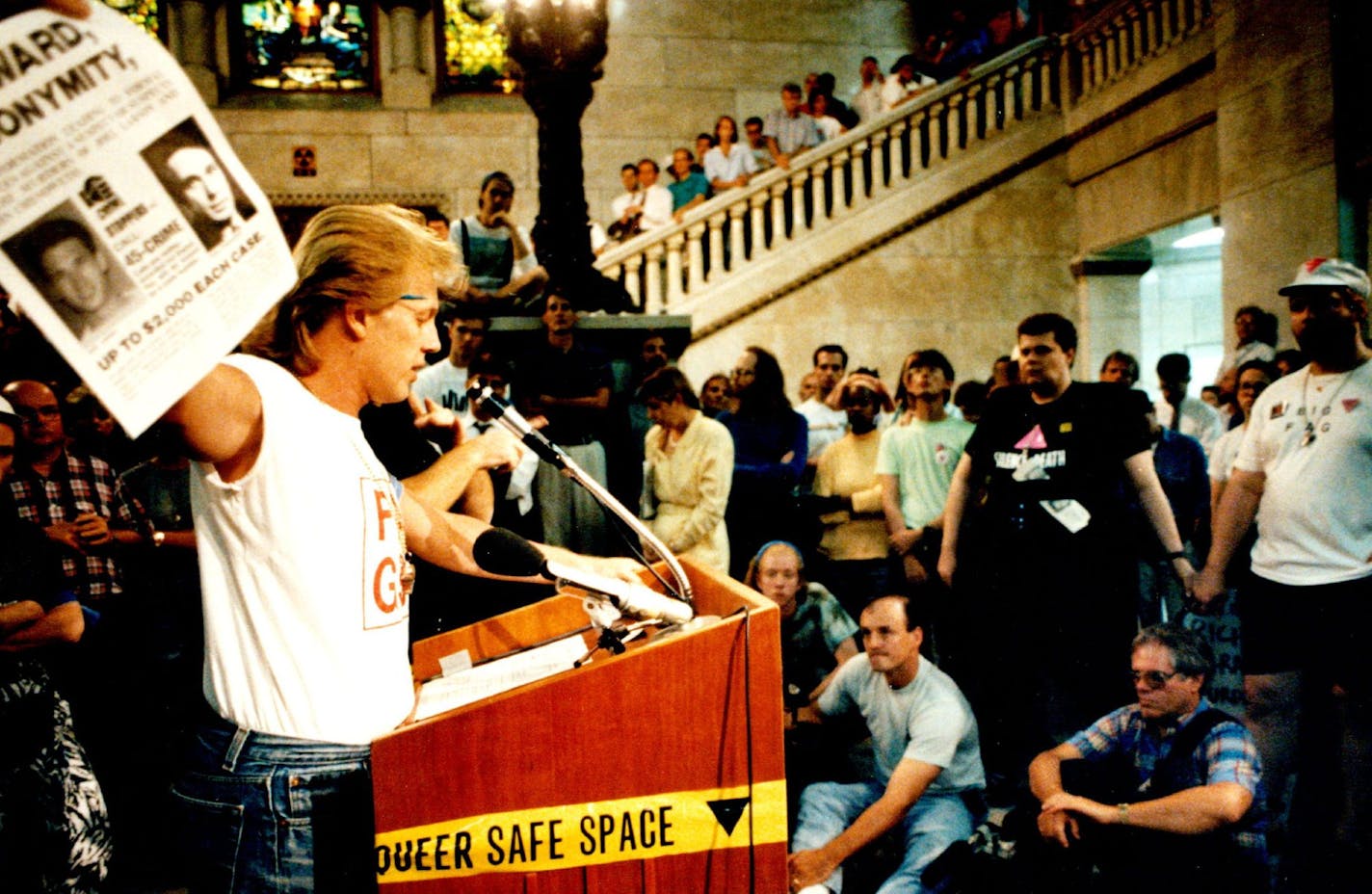 In August 1991, a march and rally was held at Minneapolis City Hall in response to attacks against gay, lesbian and bisexual people. Rick Simon, left, an activist, waved a reward poster for the murders of Joel Larson and John Chenoweth.