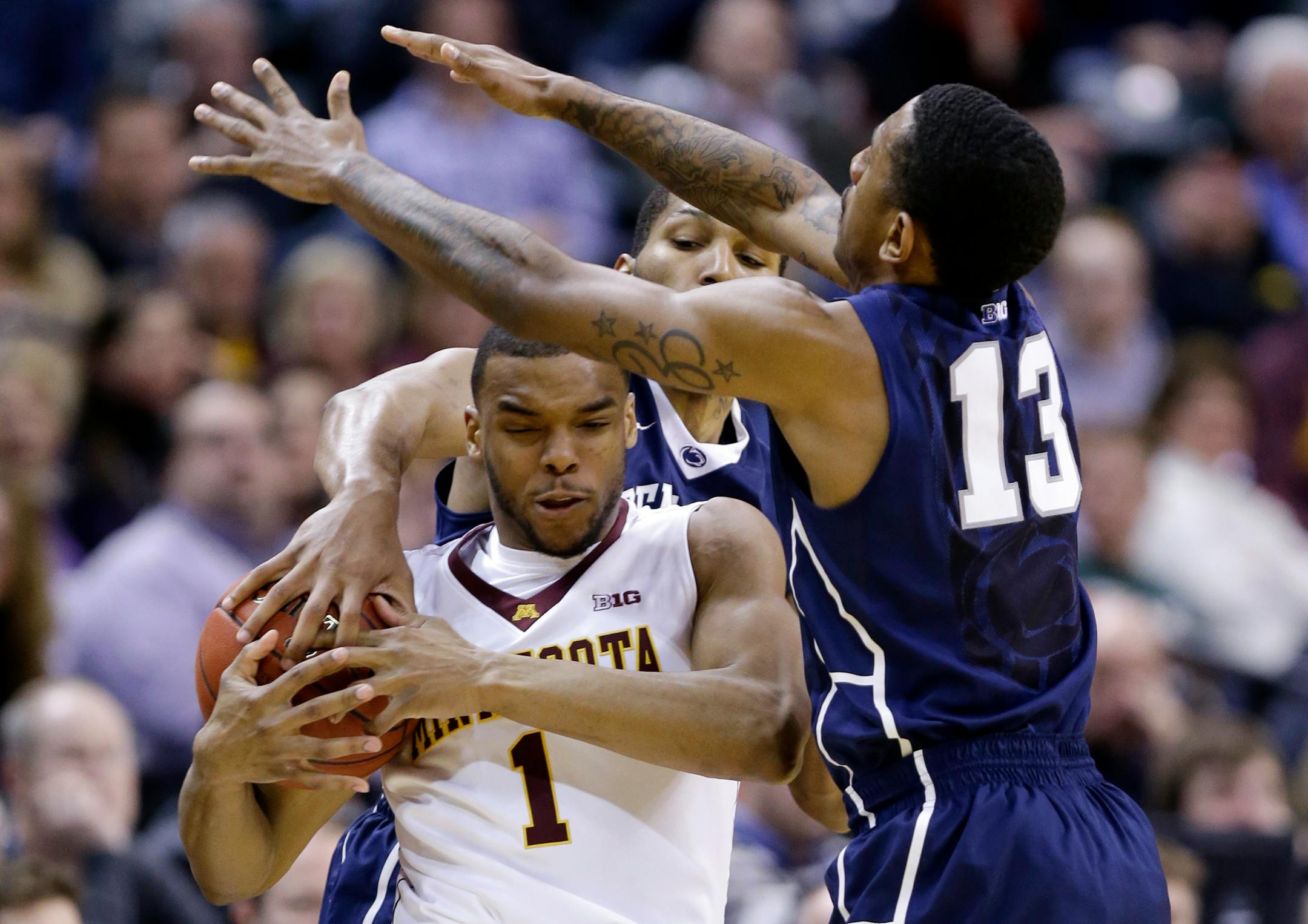 Minnesota guard Andre Hollins (1) battles for the possession of the ball against Penn State guards D.J. Newbill and Geno Thorpe (13) in the second half of an NCAA college basketball game in the first round of the Big Ten Conference tournament, Thursday, March 13, 2014, in Indianapolis. Minnesota won 63-56. (AP Photo/Michael Conroy)