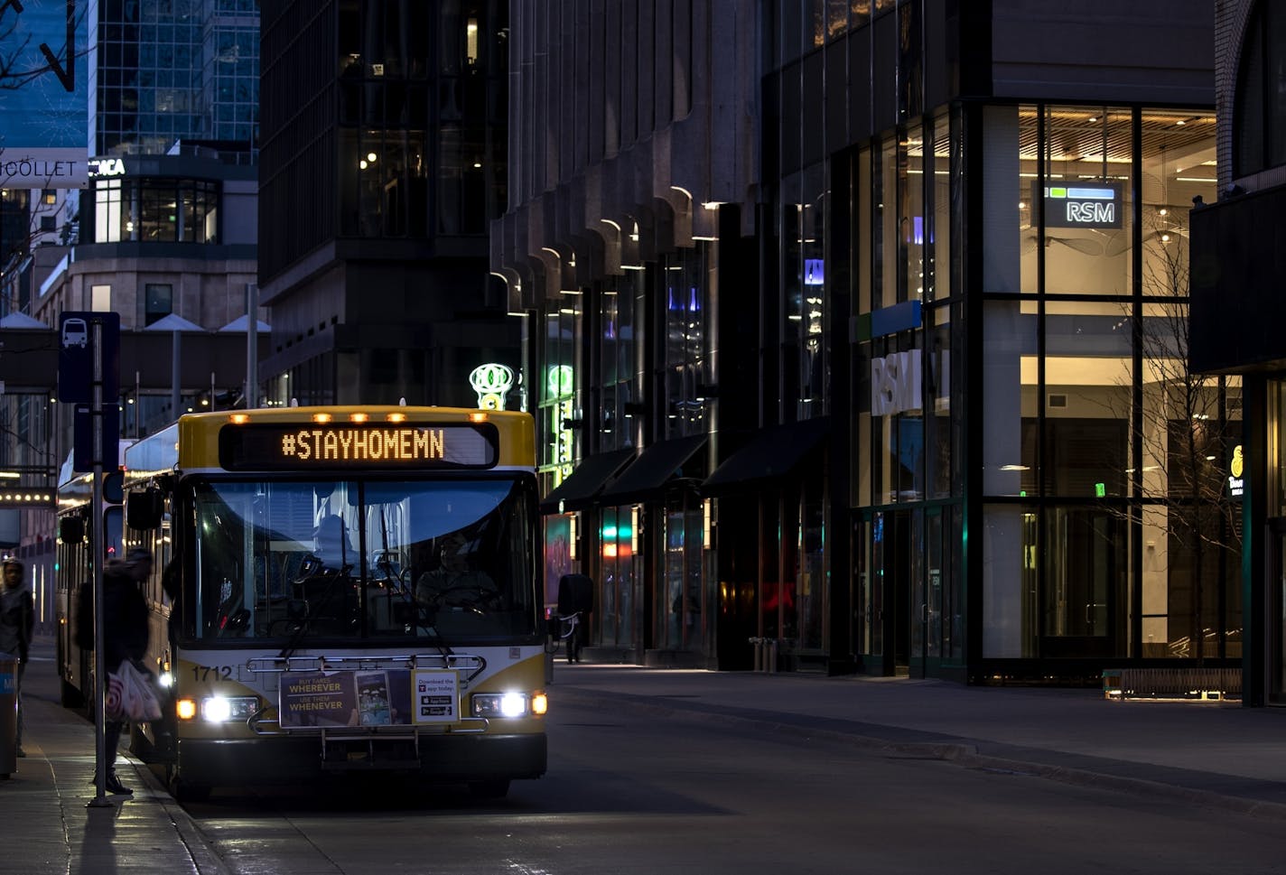 A Metro Transit bus with the hashtag #STAYHOMEMN drove down Nicollet Mall in downtown Minneapolis on Monday, March 23. Buses and trains are moving to holiday schedules after a sharp drop in ridership.