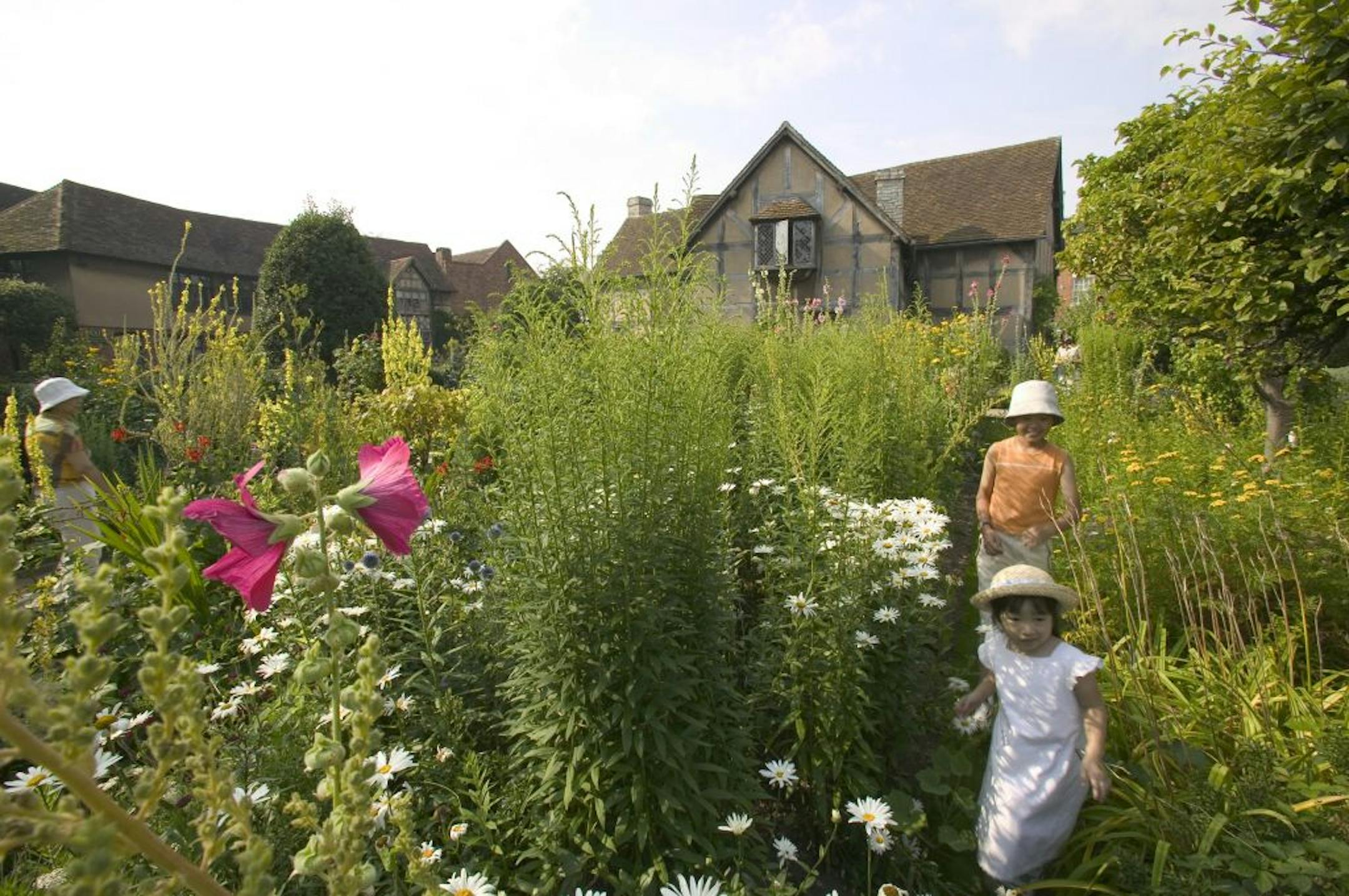 Tourists from Japan explore the garden of Shakespeare's purported birthplace in Stratford-upon-Avon, England.