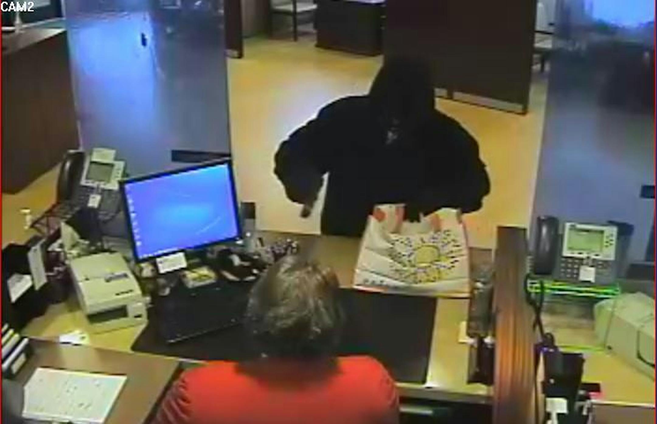 A man robs the Central Bank at 2120 Hennepin Av. S. on Tuesday, May 27, 2014. He used a black pistol and got away with some cash, according to the FBI. Authorities want the publicís help to identify him.