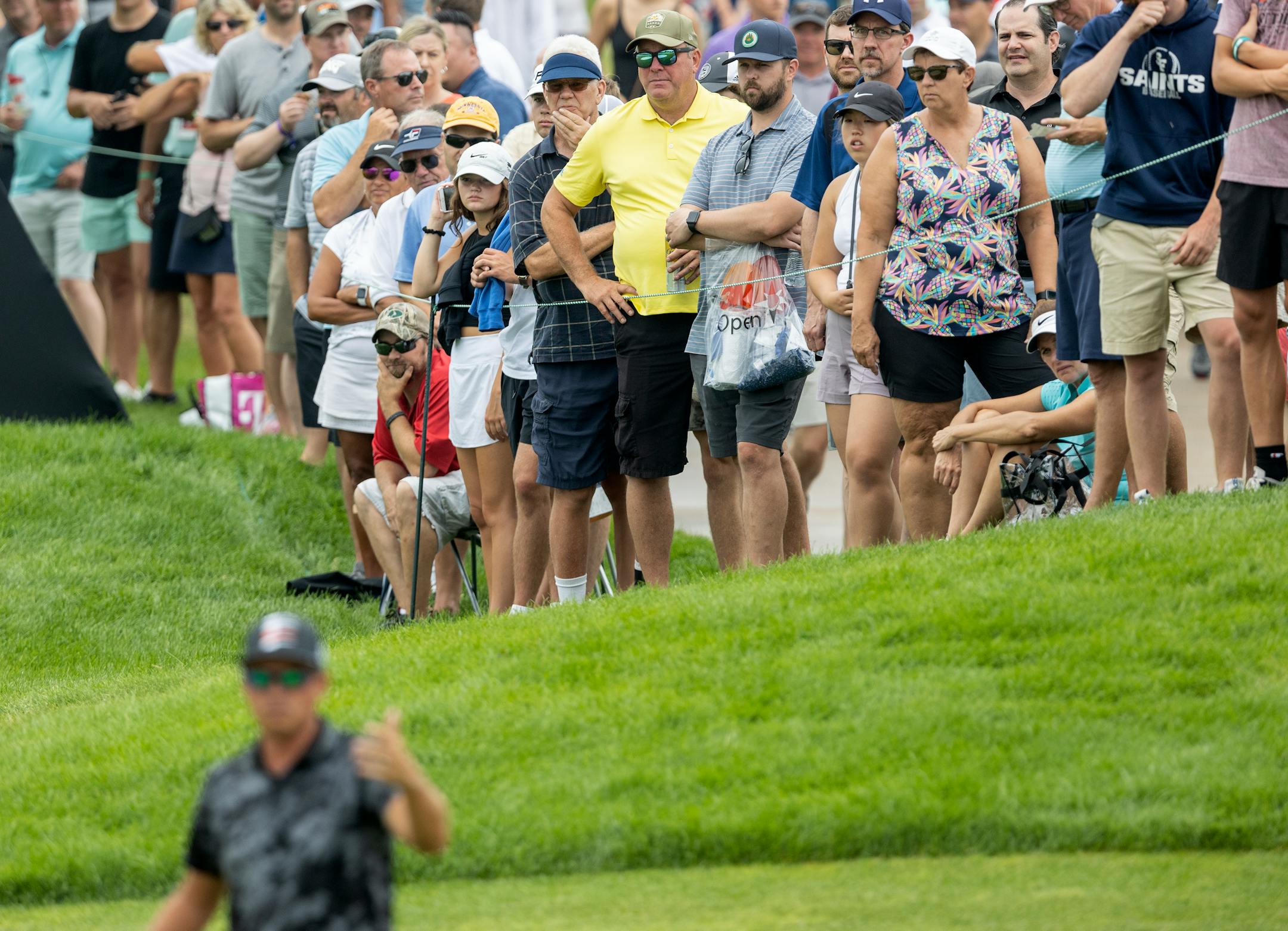 Fans watched Rickie Fowler line up a putt on the 9th hole during the first round of the 3M Open in Blaine.