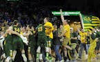 North Dakota State celebrates after an NCAA college basketball game against South Dakota State for the Summit League tournament title, Tuesday, March 