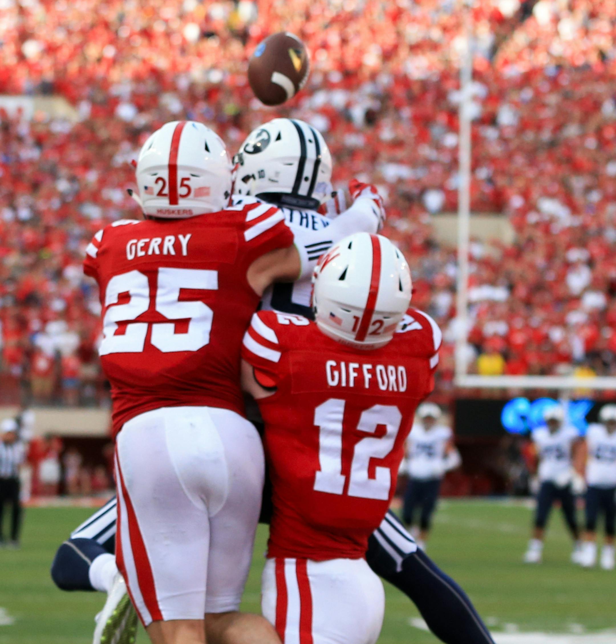 BYU wide receiver Mitch Mathews (10) catches the game winning touchdown in front of Nebraska safety Nate Gerry (25) and linebacker Luke Gifford (12) during the second half of an NCAA college football game in Lincoln, Neb., Saturday, Sept. 5, 2015. Brigham Young won 33-28. (AP Photo/Nati Harnik)