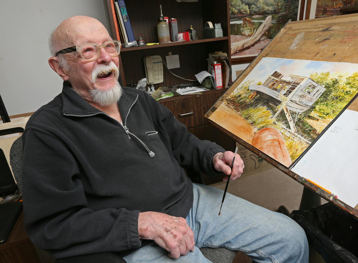 Raymer took a break from working on a new watercolor painting in his Minneapolis studio last week.