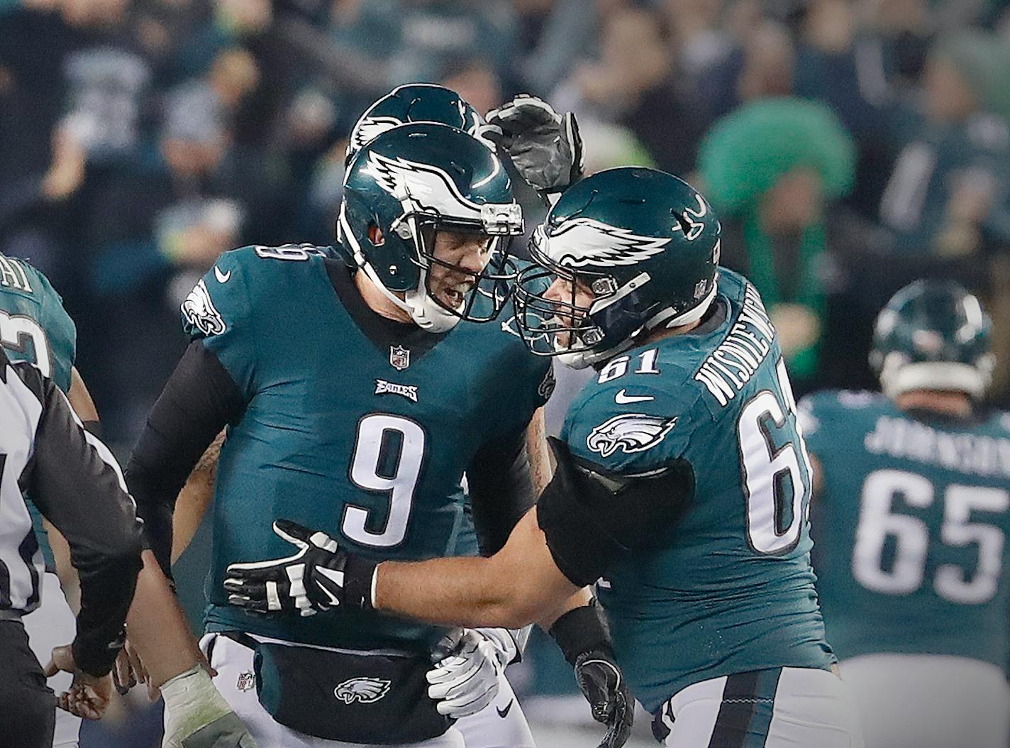 Philadelphia Eagles quarterback Nick Foles (9) celebrates a touchdown with Philadelphia Eagles defensive end Aziz Shittu (61), during the NFC Championship Game.