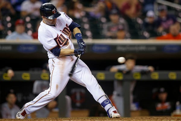Minnesota Twins' Brian Dozier hits a two-run home run against the Miami Marlins in the 11th inning of a baseball game Tuesday, June 7, 2016, in Minnea