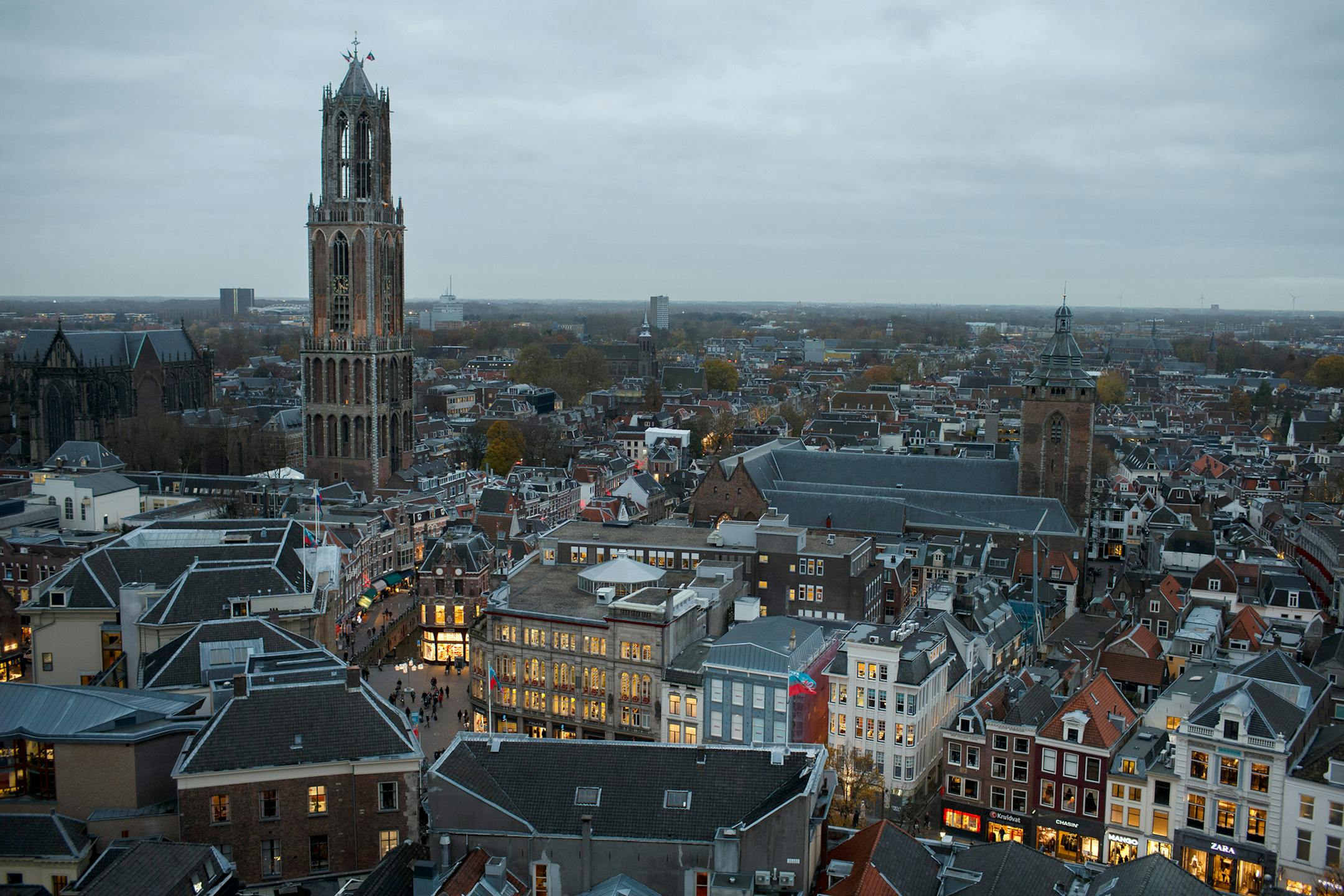 The Dom Tower of Utrecht Cathedral, left, stands as the city skyline is seen at dusk in Utrecht, Netherlands. Illustrates NETHERLANDS-UTRECHT (category t), by Diane Daniel, special to The Washington Post. Moved Tuesday, March 17, 2015. (MUST CREDIT: Jasper Juinen/Bloomberg.)