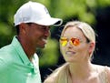 Lindsey Vonn speaks to Tiger Woods during the Par 3 contest at the Masters golf tournament Wednesday, April 8, 2015, in Augusta, Ga. (AP Photo/Charlie