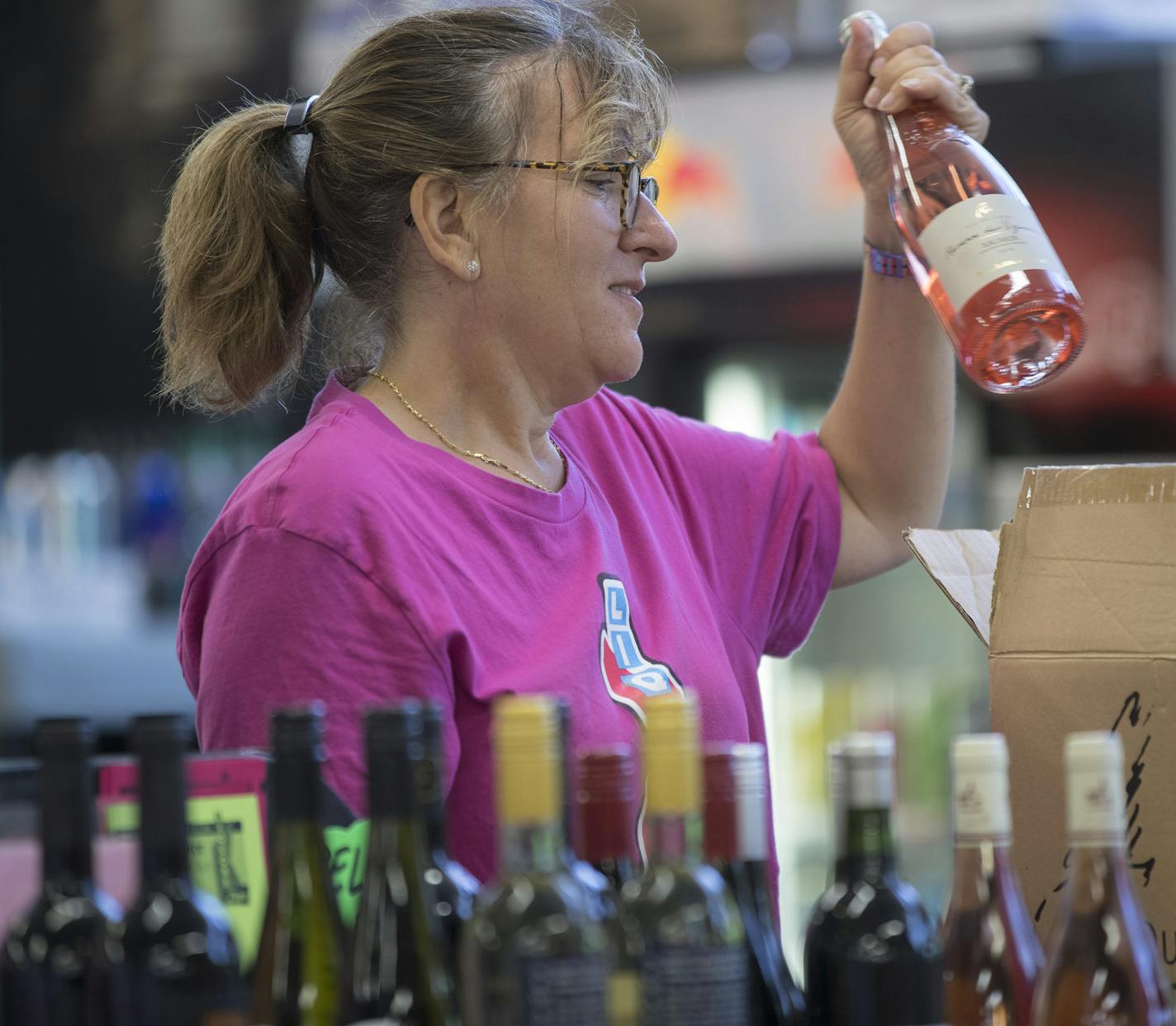 Jennifer Schoenzeit co-owner of Zipps Liquors with her brother Andy Schoenzeit checked out two case of wine for customers Thomas Johnson and, Lea Johnson Minnesota July 2, 2017 in Minneapolis, MN. Her father Mickey started the family Liquor business in 1961.] JERRY HOLT &#xef; jerry.holt@startribune.com