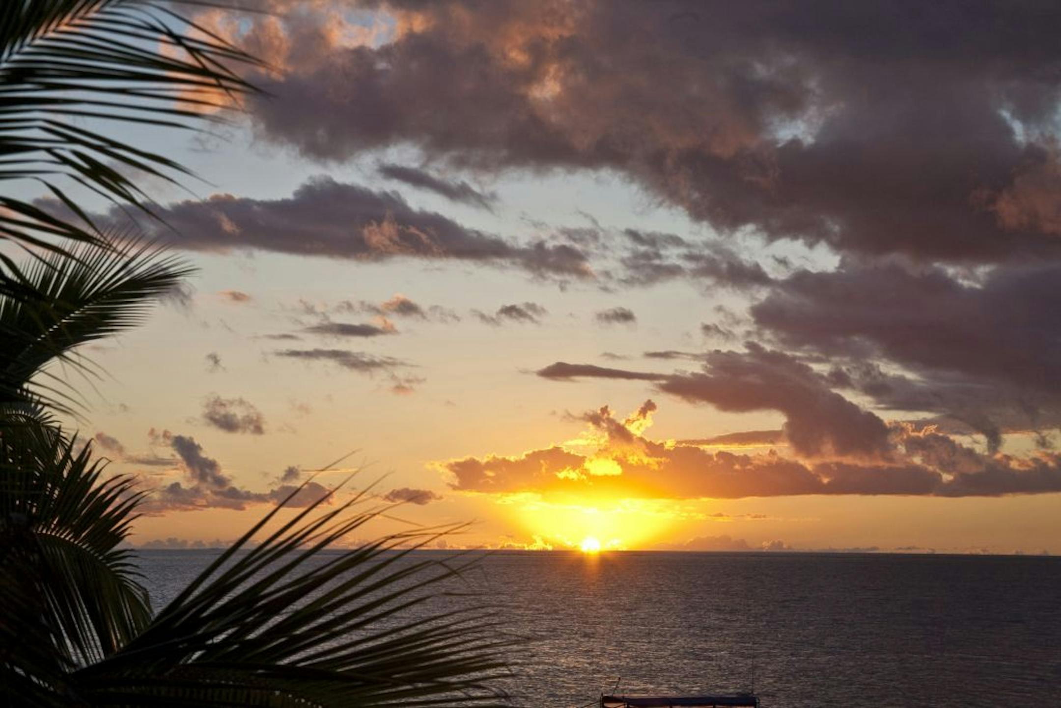 The sun sets over the lagoon, in the Mamanuca Island Group, Fiji.