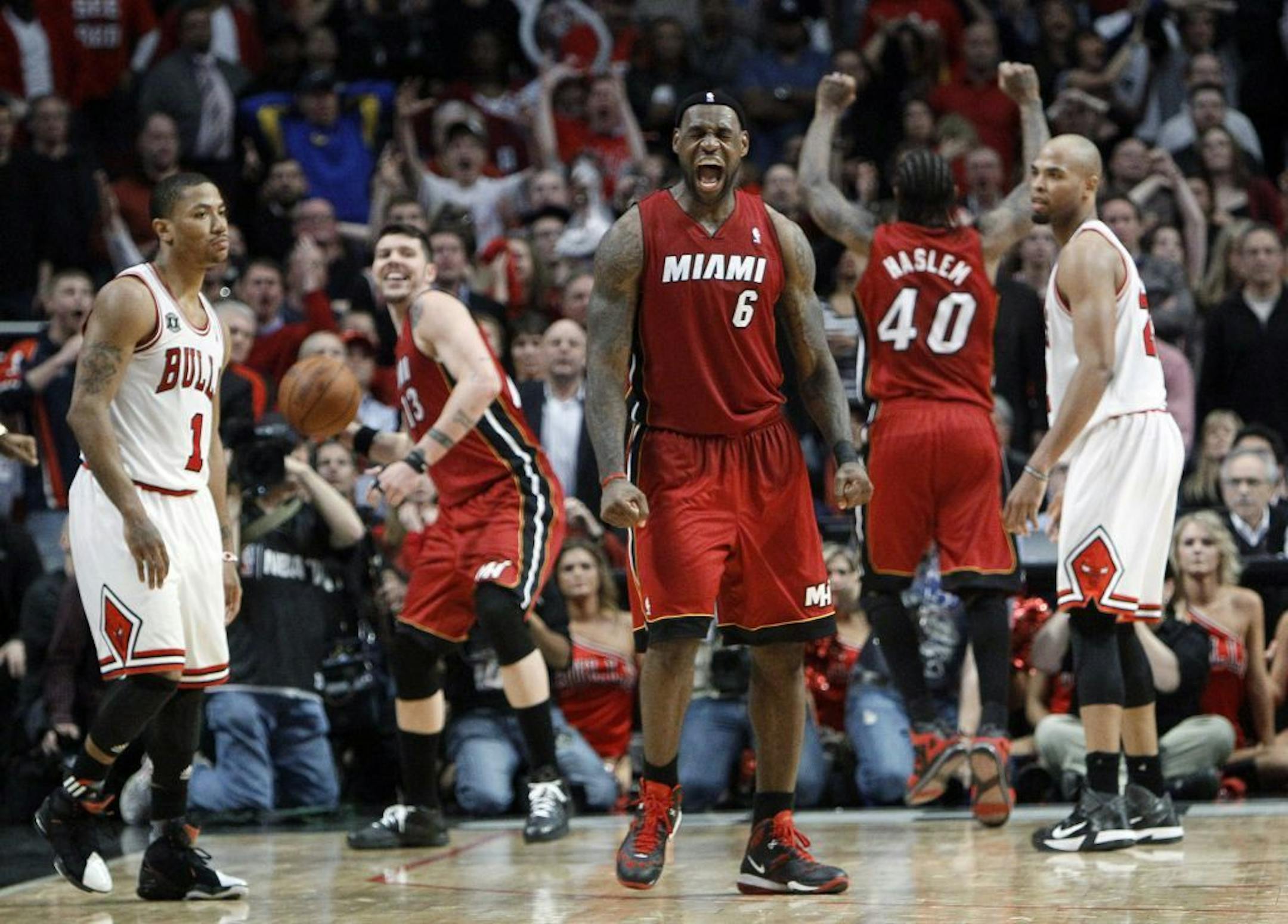 Miami's LeBron James, center, began the celebration after the Heat rallied late to beat the Bulls 83-80 on Thursday night in Chicago and advance to the NBA Finals. The Heat won the series 4-1 and will face Dallas for the NBA title, beginning Tuesday in Miami.