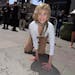 Jane Fonda compares her hands in her father, Henry Fonda's hand and footprint as the 2013 TCM Classic Film Festival honors Jane Fonda with a handprint