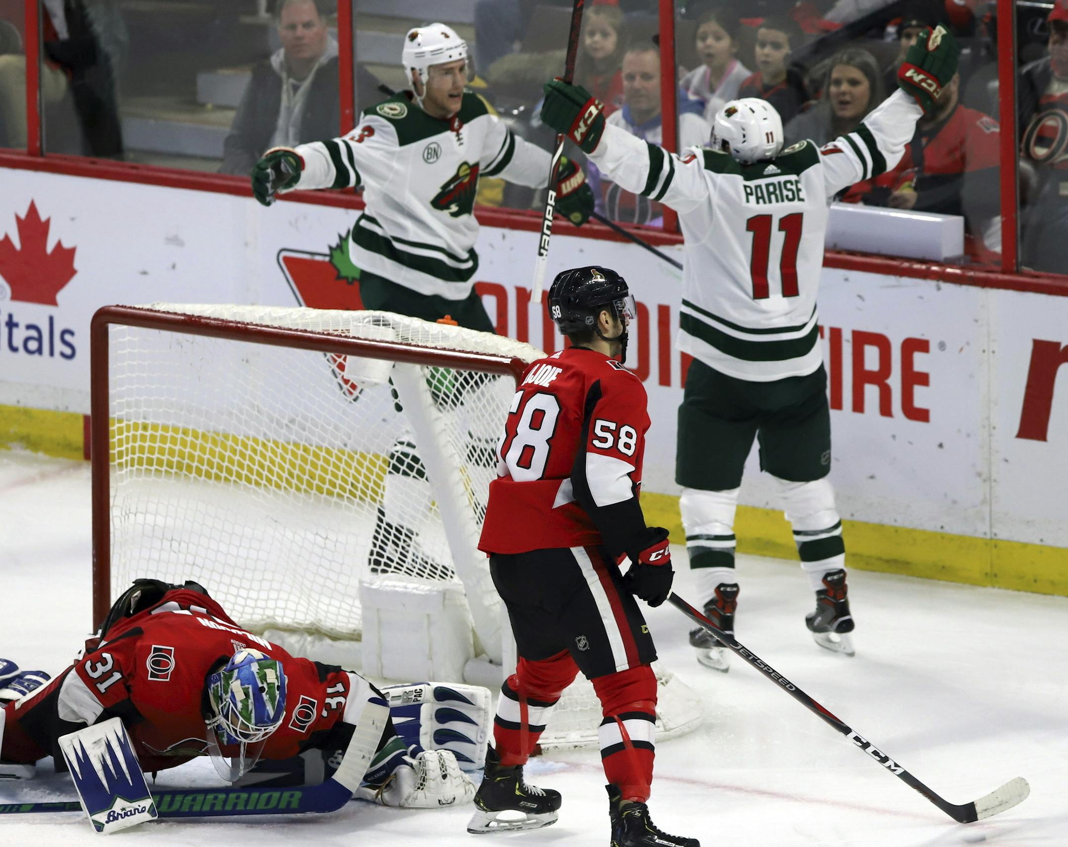 Minnesota Wild's Zack Parise (11) celebrates his goal against the Ottawa Senators with teammate Charlie Coyle (3), as Senators goaltender Anders Nilsson (31) and Maxime Lajoie react, during the third period of an NHL hockey game in Ottawa, Saturday, Jan. 5, 2019. (Fred Chartrand/The Canadian Press via AP)