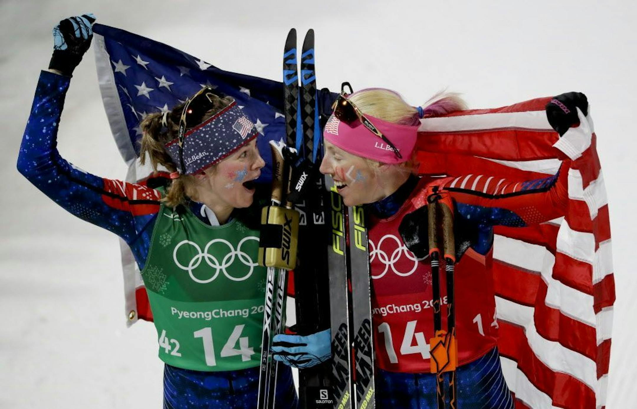 United States' Jessie Diggins, left, and Kikkan Randall celebrate after winning the gold medal in the women's team sprint freestyle cross-country skiing final at the 2018 Winter Olympics.