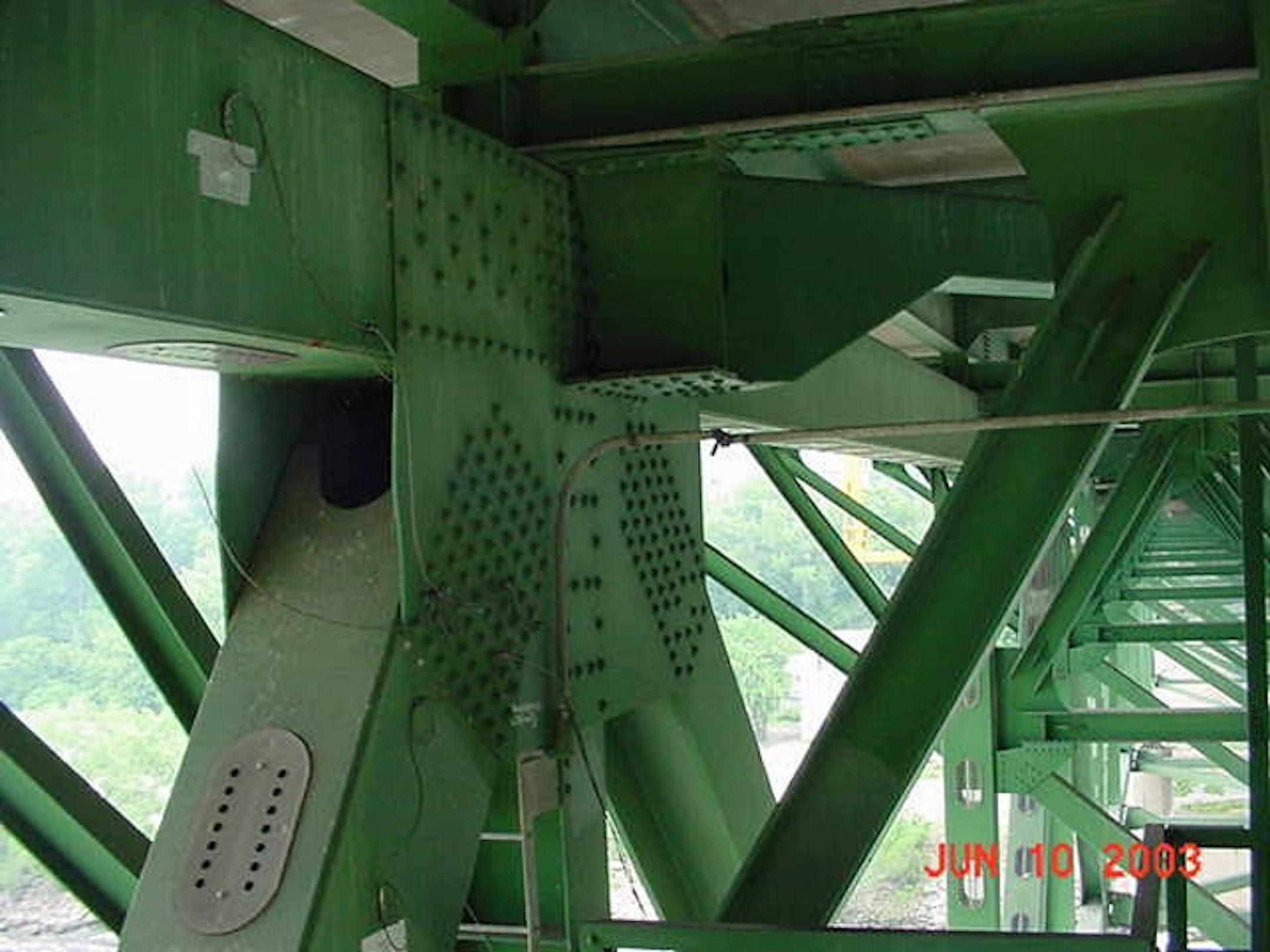 Bent gusset plates on the Interstate 35 W bridge are seen, center, in this 2003 photo released by the National Transportation Safety Board. Old photos of the bridge show two gusset plates were visibly bent as early as 2003 -- four years before the span collapsed into the Mississippi River, killing 13 people. The plates are in areas believed to be among the first points of failure, and the photos are stamped with the dates June 10, 2003 and June 12, 2003.