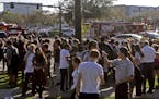 Students are released from a lockdown following a shooting at Marjory Stoneman Douglas High School in Parkland, Fla., on Wednesday, Feb. 14, 2018. (Jo