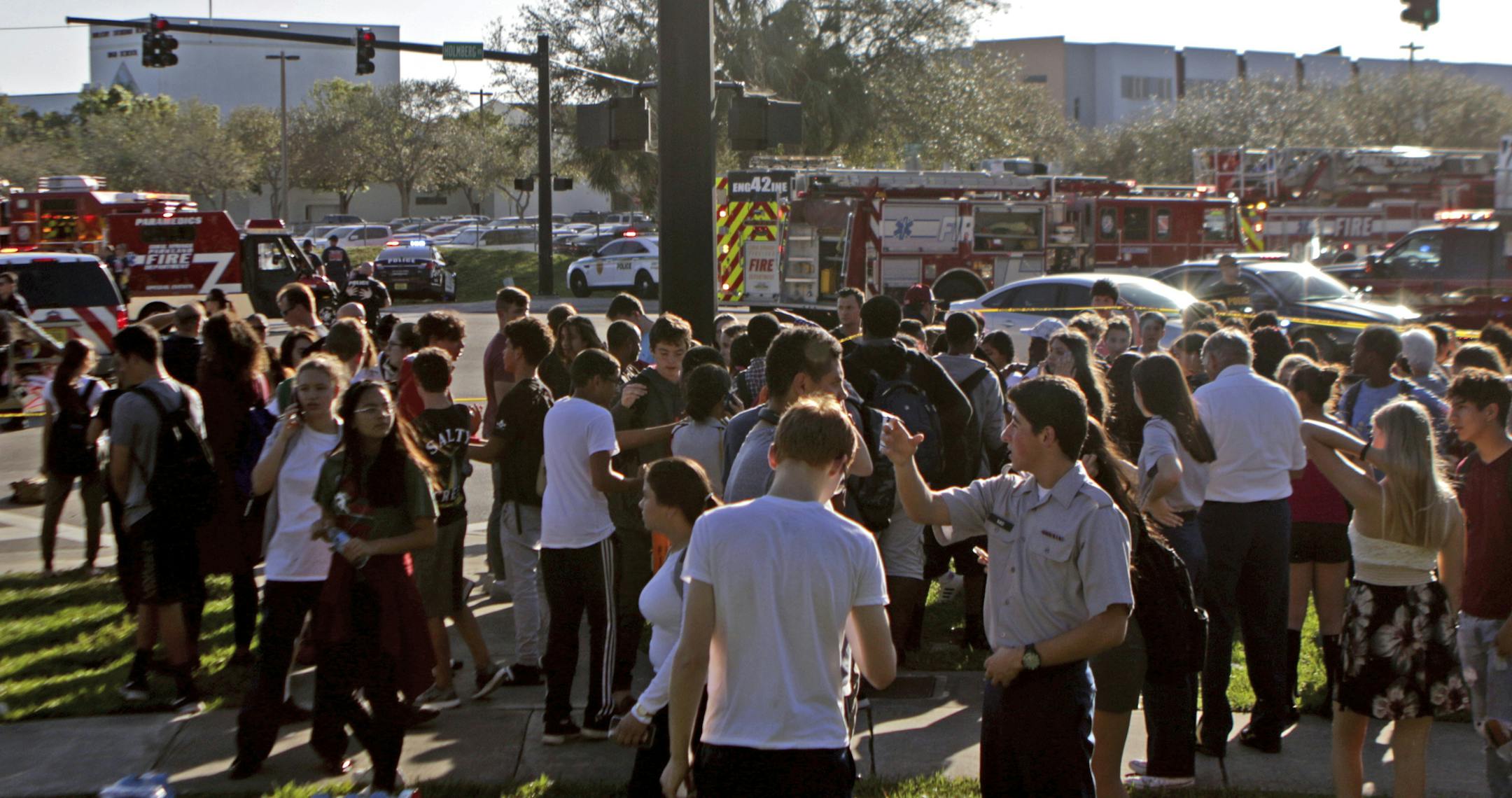 Students are released from a lockdown following a shooting at Marjory Stoneman Douglas High School in Parkland, Fla., on Wednesday, Feb. 14, 2018. (John McCall/South Florida Sun-Sentinel via AP)