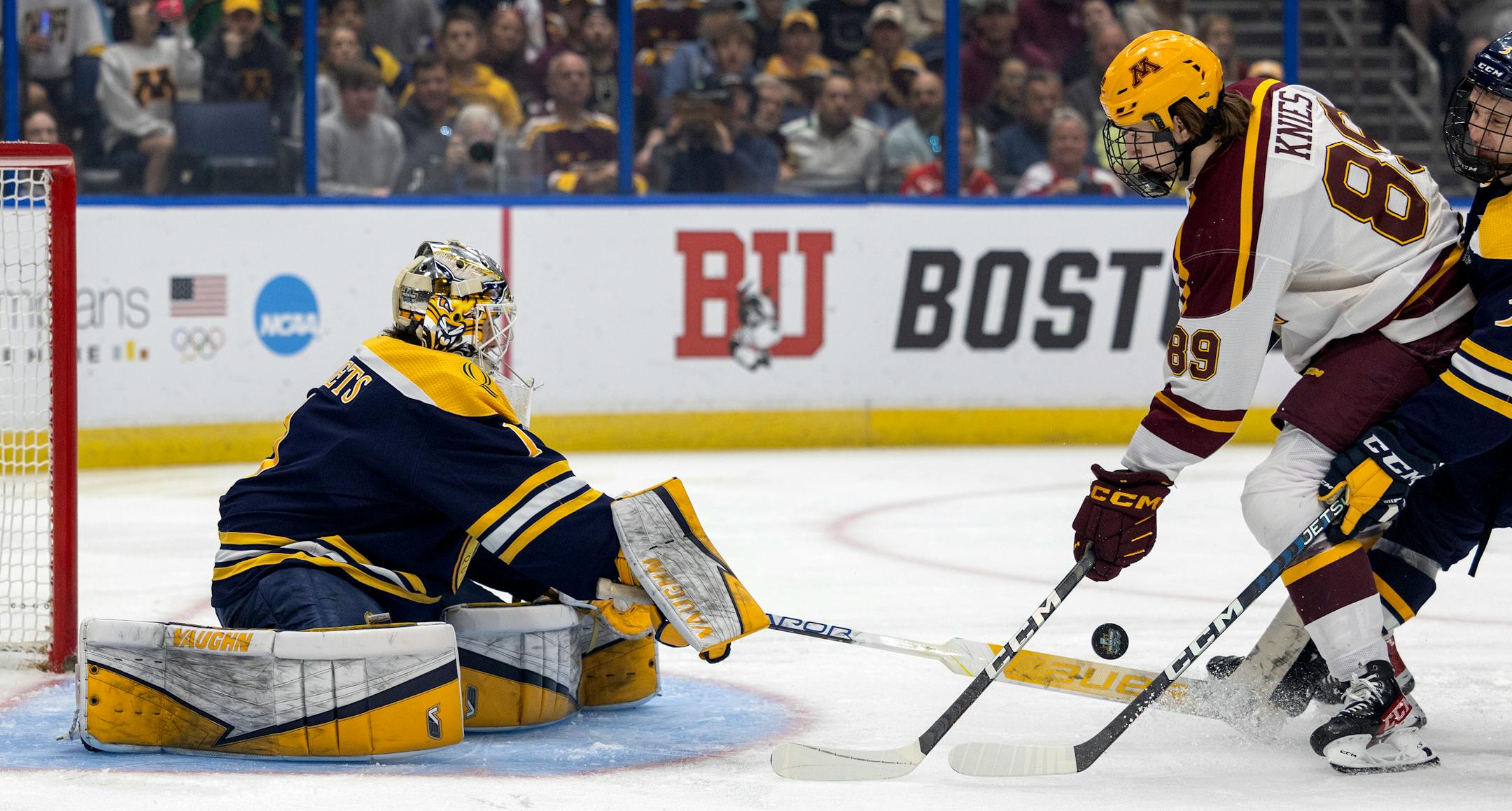 Quinnipiac goalie Yaniv Perets (1) blocks a shot by Matthew Knies (89) of Minnesota in the first period.