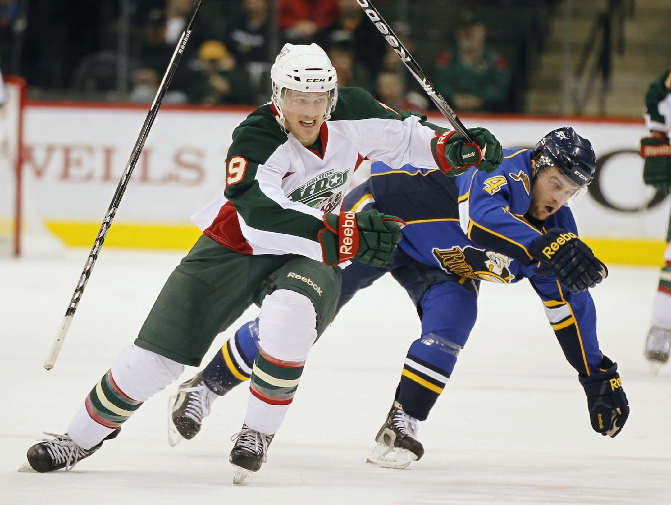 At the Xcel Center in AHL game between the Houston Aeros and the Peoria Rivermen, Aeros Jarod Palmer(19) and Rivermen Derek Peltier(4) collide.
