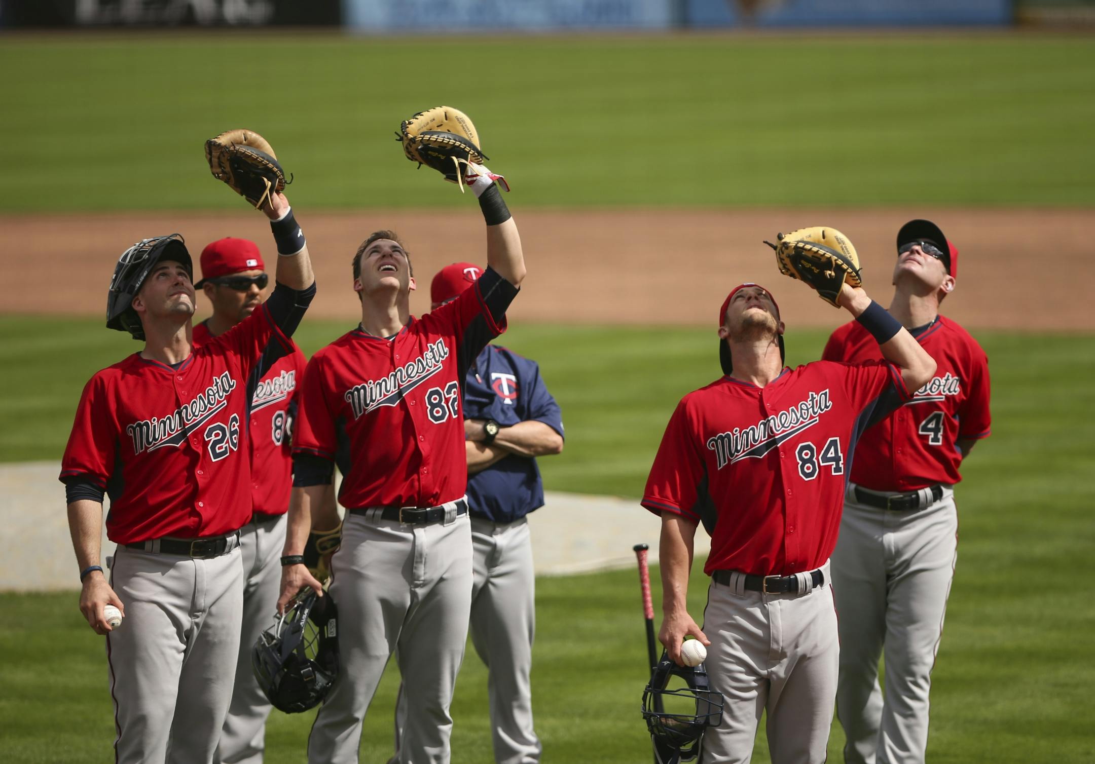 Twins catcher invitees Eric Fryer (26), Mitch Garver (82), Dan Rohlfing (84), from left, and Manager Paul Molitor (4) kept their eyes on a pop fly during a drill for catchers Monday morning at Hammond Stadium.