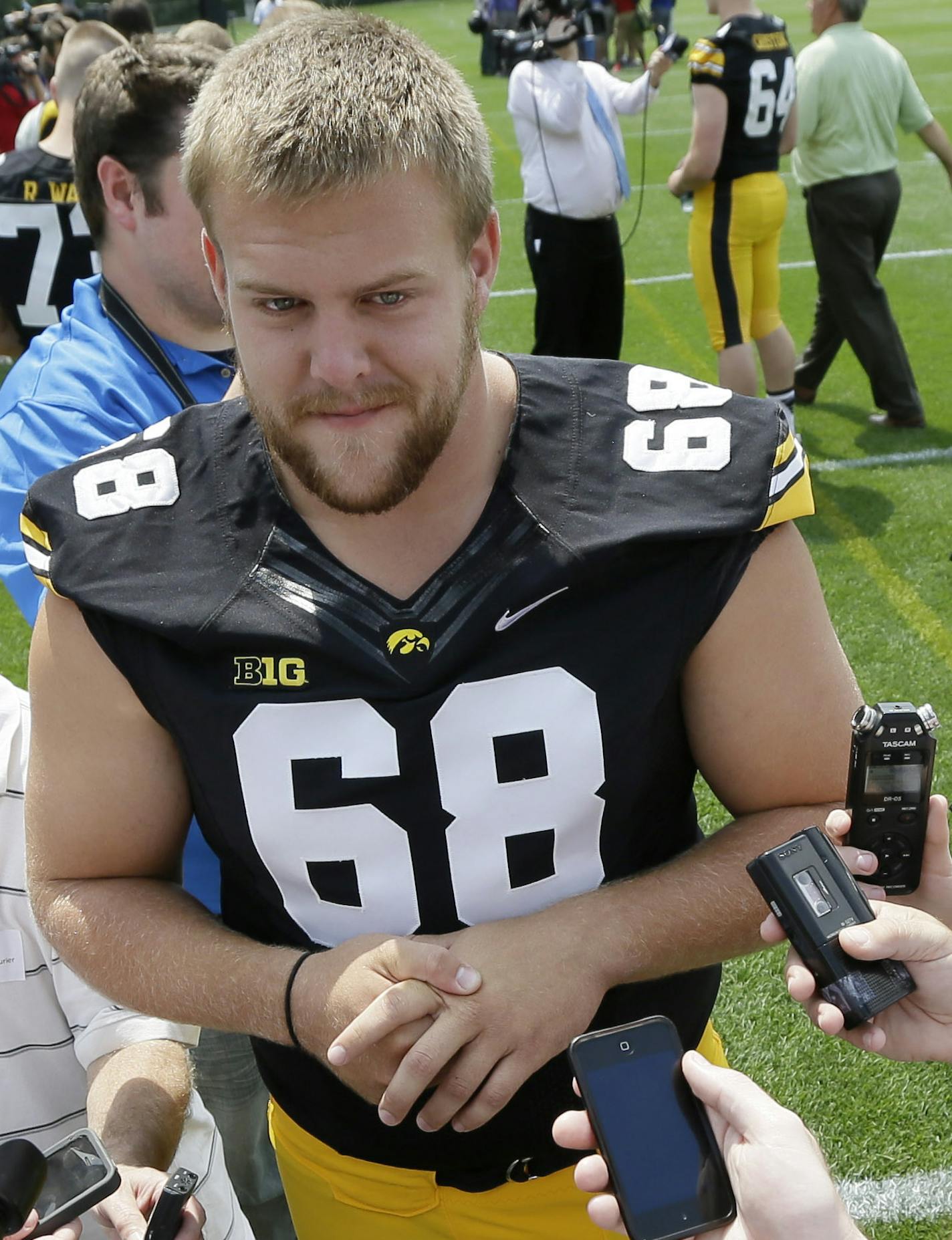 Iowa offensive linesman Brandon Scherff (68) speaks to the media during Iowa's annual college football media day, Monday, Aug. 4, 2014, in Iowa City, Iowa. (AP Photo/Charlie Neibergall)