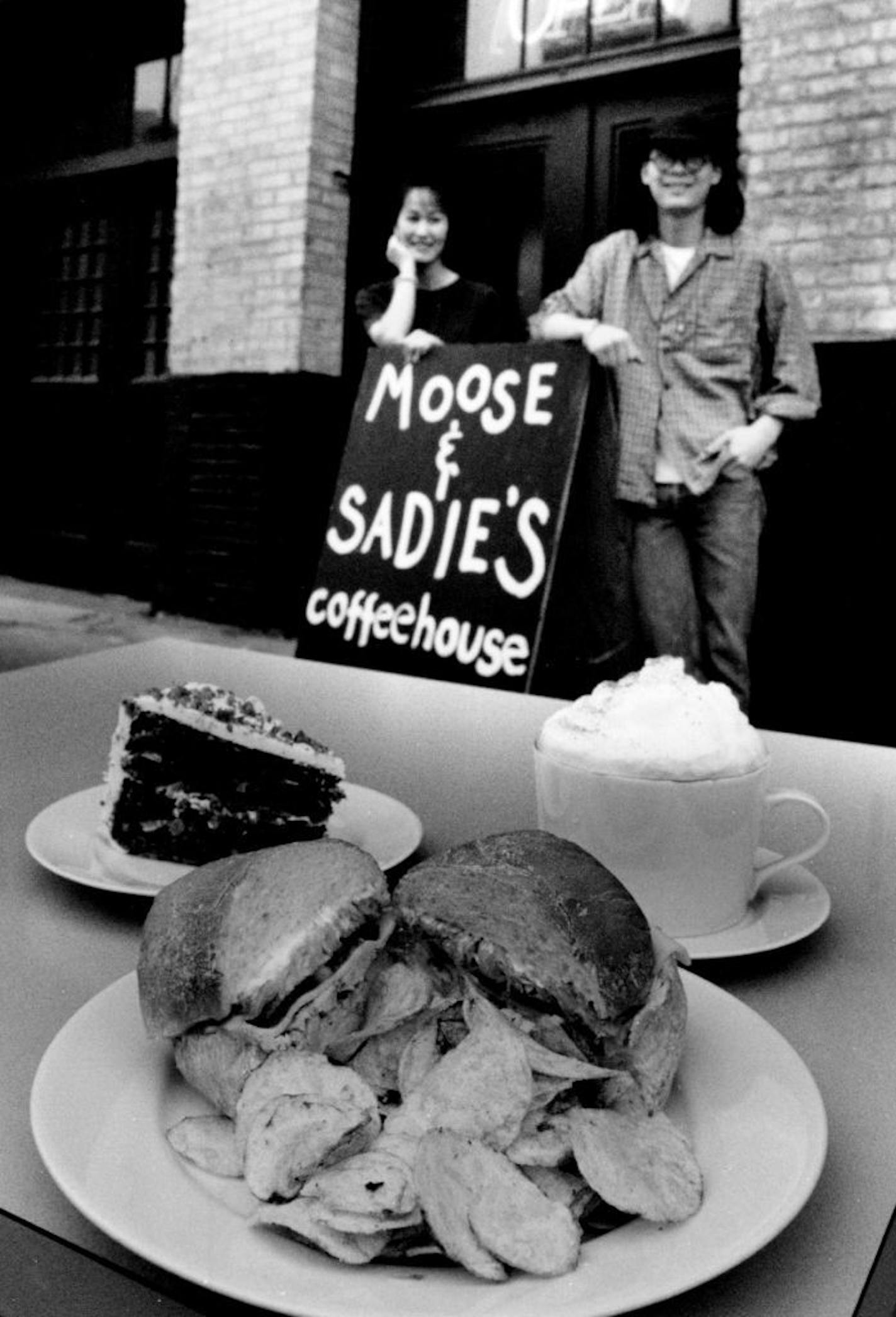 February 21, 1992 Food to Go--Moose & Sadie's Cofeehouse Take out items: A fresh roasted turkey sandwich, carrot cake from The Alice factor, and a double cappuccino, photographed outside the coffee house at 212 Third Av. N. Also, same photo with co-owners Lisa Chen and Peter Kirihara by the sign board for the cofffee house February 26, 1992 Charles Bjorgen, Minneapolis Star Tribune