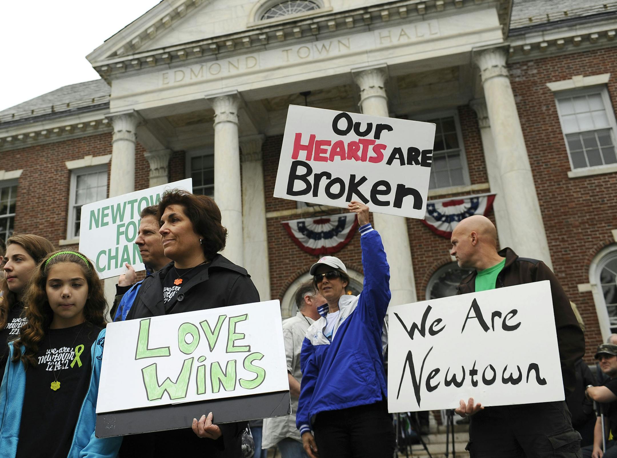 People gather during a ceremony on the six-month anniversary honoring the 20 children and six adults gunned down at Sandy Hook Elementary school on Dec. 14, 2012 at Edmond Town Hall in Newtown, Conn., Friday, June 14, 2013.