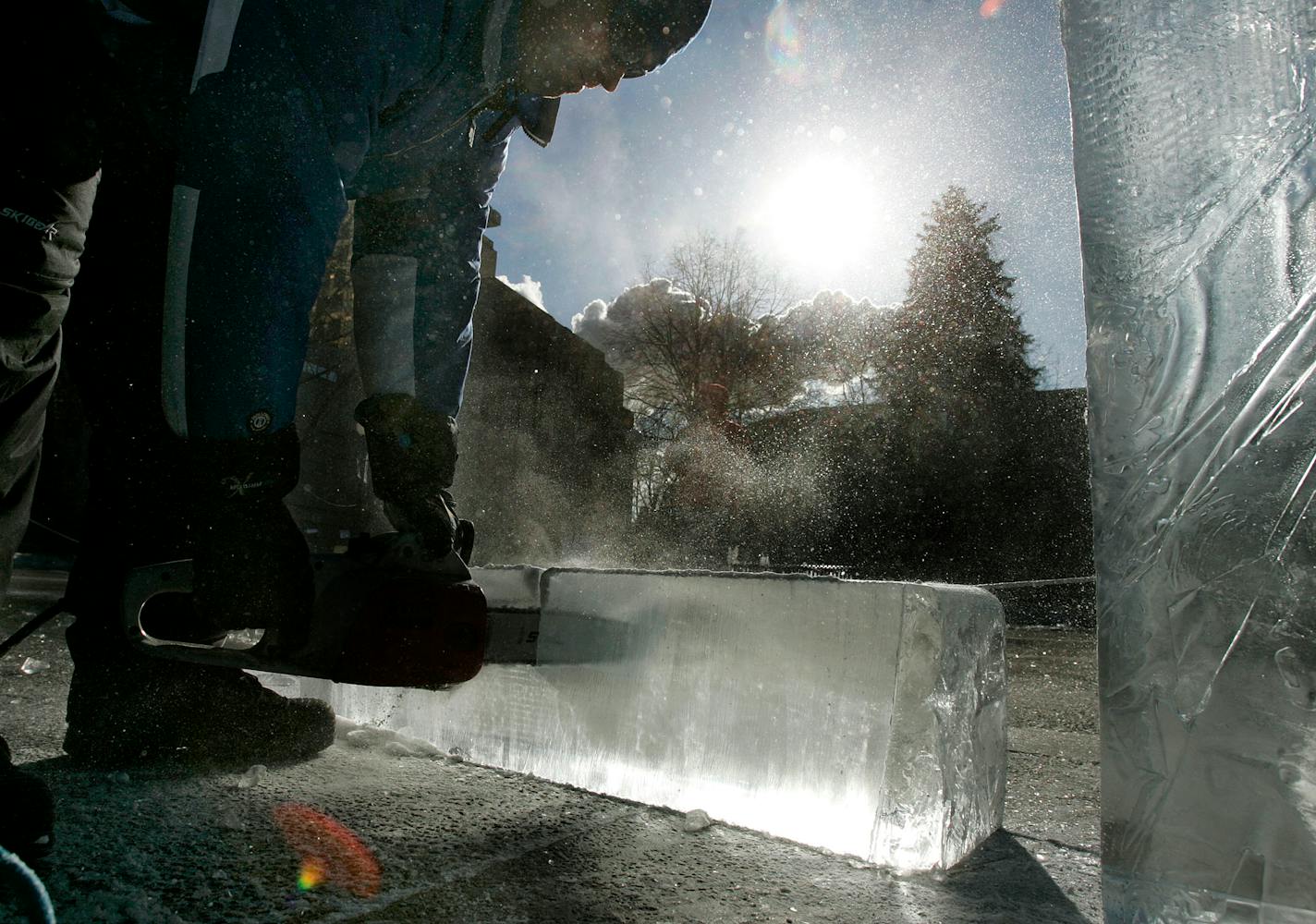 Chris Swarbrick of Richfield used a chainsaw to begin carving a dolphin sculpture at Rice Park as part of this year's Winter Carnival. Planners are already hard at work on next year's festivities.
