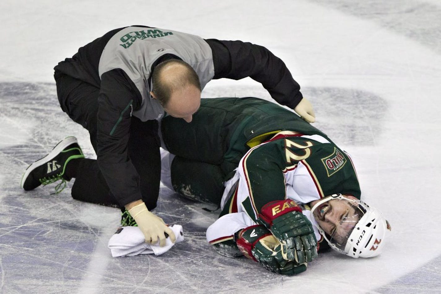 Minnesota Wild's Cal Clutterbuck is attended to after being hit by Edmonton's Taylor Hall.