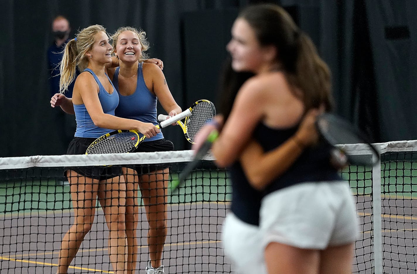 Minnetonka High doubles teammates Annika Elvestrom, left to right, and Karina Elvestrom, hug after winning their match against Julia Baber and Paige Sargent, of Century High during the Class 2A Girls' tennis state doubles championship at the Baseline Tennis Center Saturday, Oct. 30, 2021, in Minneapolis, Minn. ] DAVID JOLES • david.joles@startribune.com