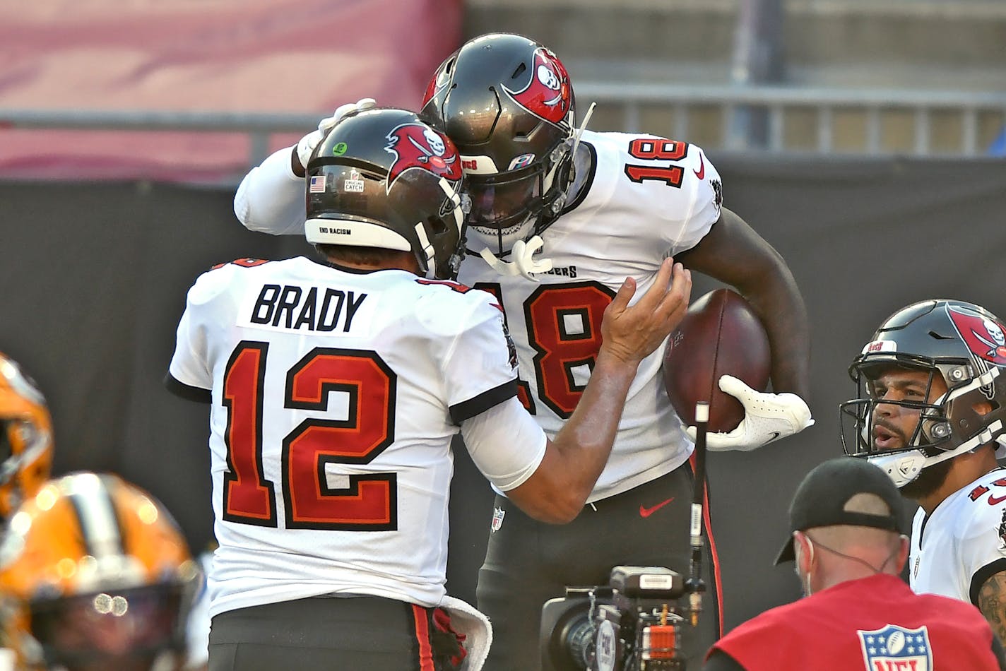 Tampa Bay Buccaneers wide receiver Tyler Johnson (18) celebrates with quarterback Tom Brady (12) after Johnson caught a 2-yard touchdown pass against the Green Bay Packers during the first half of an NFL football game Sunday, Oct. 18, 2020, in Tampa, Fla. (AP Photo/Jason Behnken)