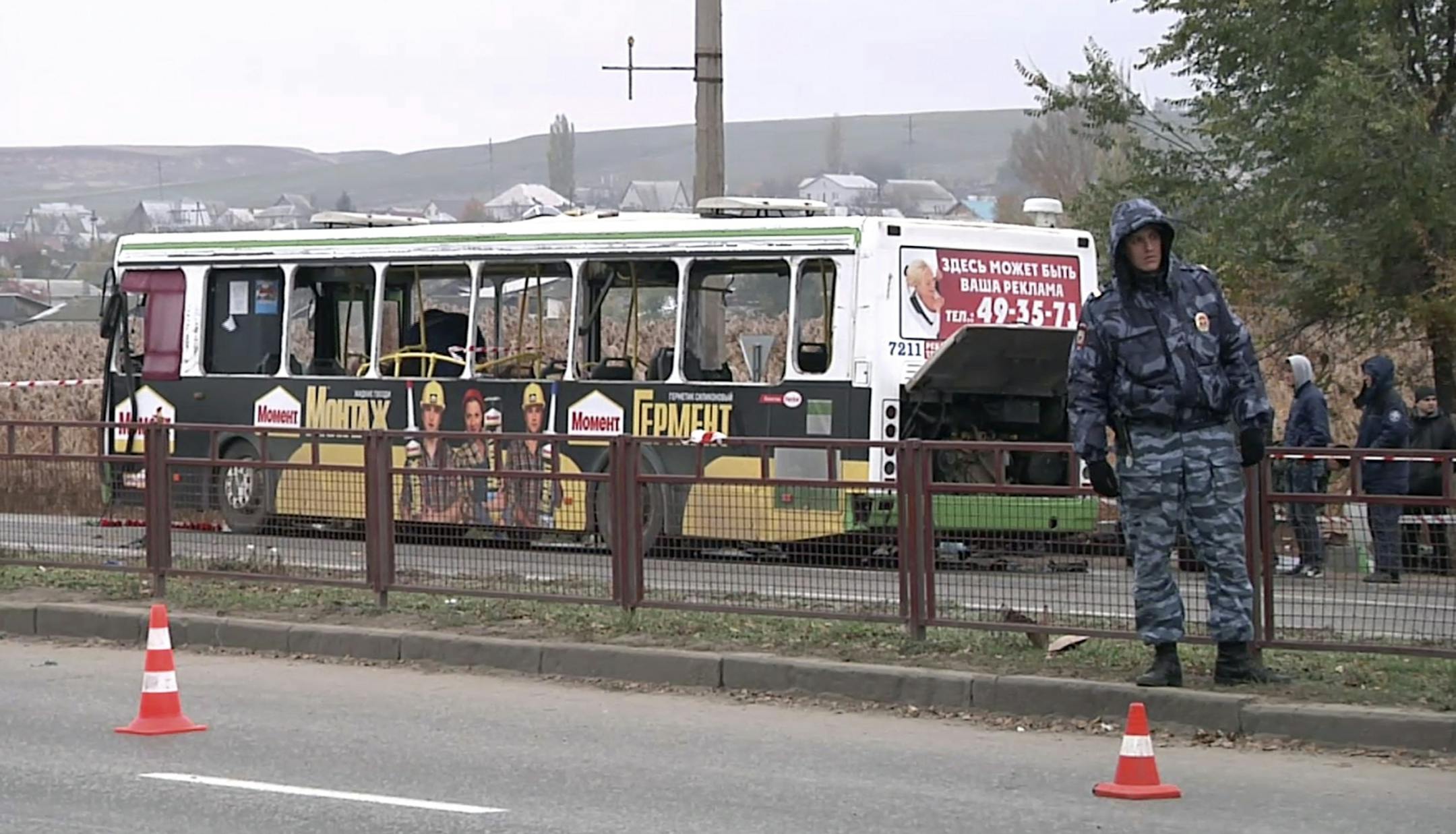 In this image made from video, experts and officials examine a wreckage of a bus in Volgograd, Russia Tuesday, Oct. 22, 2013. A female suicide bomber blew herself up on the city bus in southern Russia on Monday, killing six people and injuring about 30, officials said. The attack in Volgograd added to security fears ahead of the Winter Olympics in Sochi.