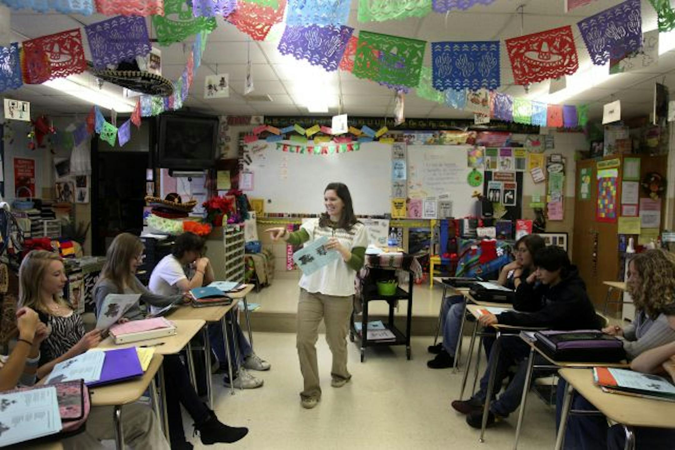 Rachel Pierce, an eighth-grade Spanish teacher at Forest Lake Southwest Junior High, sang Christmas songs in Spanish with her students. Usually public schools and charter schools operate with suspicion keeping them apart. But a Forest Lake initiative has changed that.