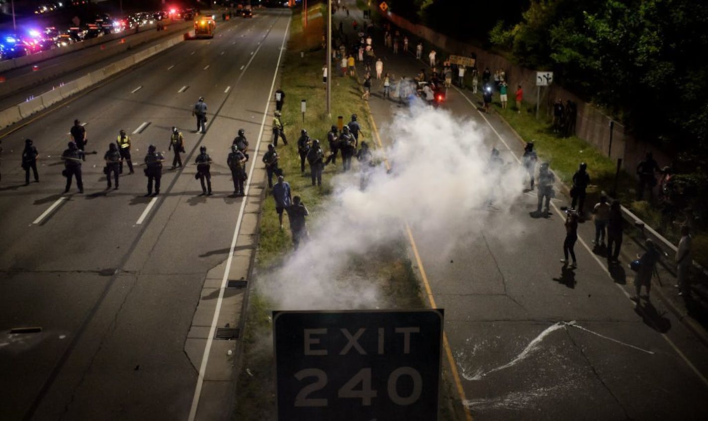 Smoke bombs floated through the air, used by police during a protest that shut down I-94 for hours to dissipate demonstrators.