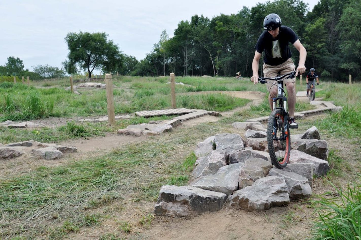 Warren Bartholomew of Burnsville rides over a rock garden at the new skills area at the Lebanon Hills Mountain Bike Trail.