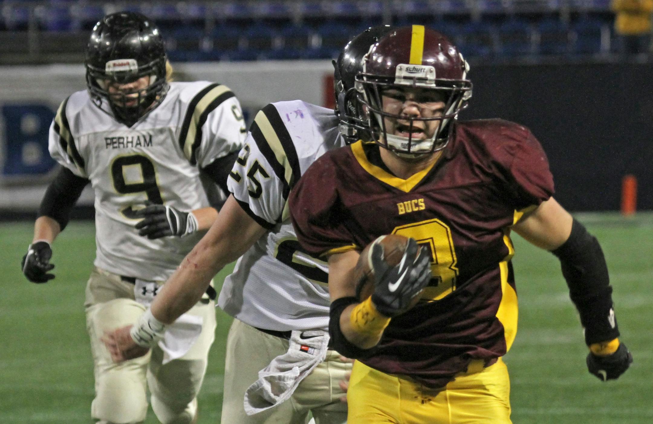 Minnesota Prep Bowl Semi-Finals, Class 3A, Perham vs. Blue Earth Area, 11/17/12, played at the Metrodome. (left to right) The Perham defense gave chase as Blue Earth Area's Carter Hanson sprinted into the endzone for the first Buccaneers touchdown.
