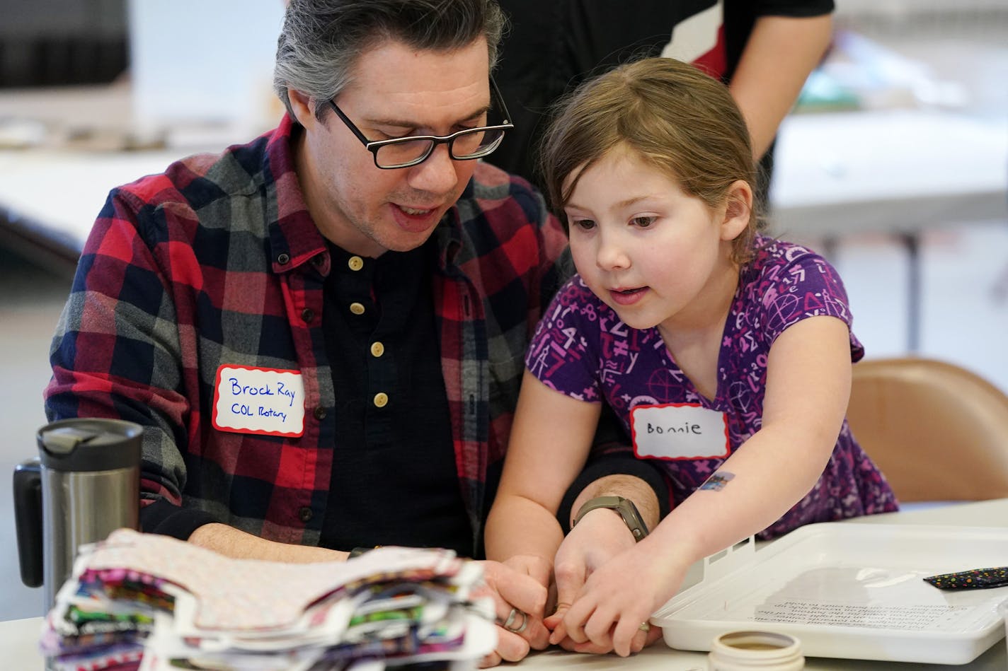 Brock Ray of New Hope worked alongside his daughter Bonnie, 7, to line up materials for the feminine hygiene kits. ] ANTHONY SOUFFLE &#x2022; anthony.souffle@startribune.com Minneapolis City of Lakes Rotary Club held a volunteer event to support the Twin Cities chapter of the nonprofit Days for Girls Saturday, Feb. 29, 2020 at the Northeast United Methodist Church in northeast Minneapolis. The "Sew-a-thon" made feminine hygiene kits for girls in developing countries so they can continue to stay