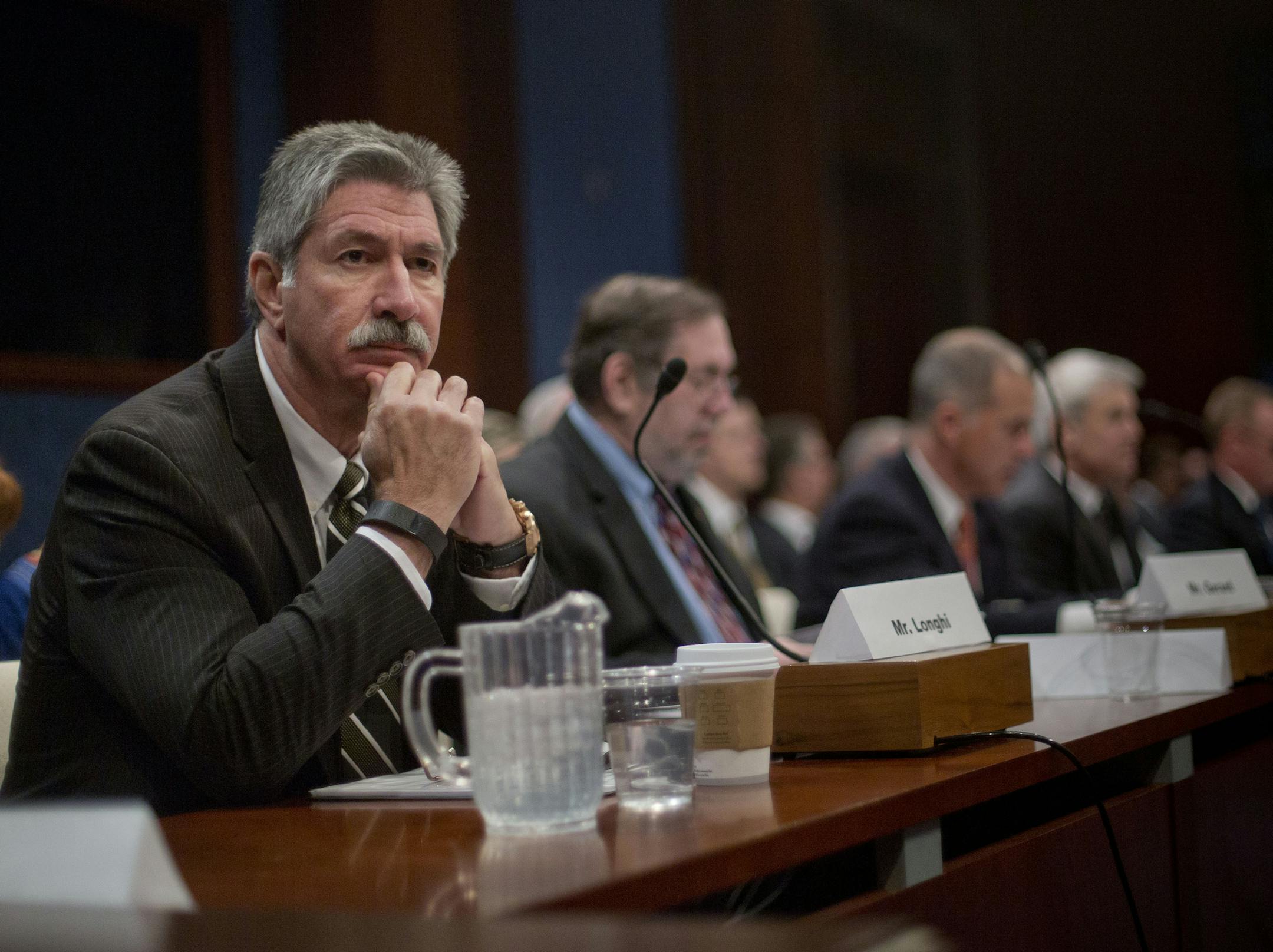 US Steel President and CEO Mario Longhi, left, waits to speak on Capitol Hill in Washington, Thursday, April 14, 2016, during a hearing on the State of the U.S. steel industry with testimony from industry executives and labor representatives before the Congressional Steel Caucus. (AP Photo/Pablo Martinez Monsivais)