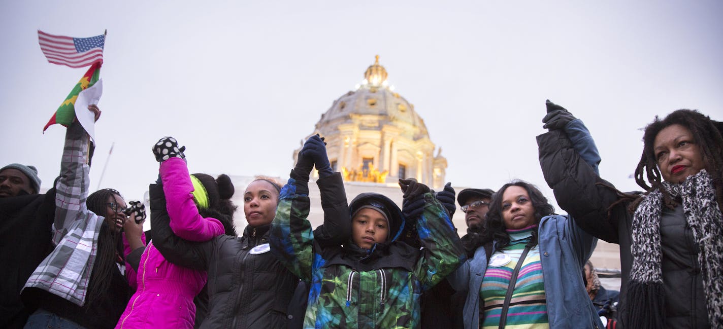 The family of Marcus Golden, including his mother Ericka Cullars-Golden, second from right, stand on the Capitol steps during a vigil for Marcus during the ReclaimMLK march in St. Paul on Monday, January 19, 2015. ] LEILA NAVIDI leila.navidi@startribune.com /