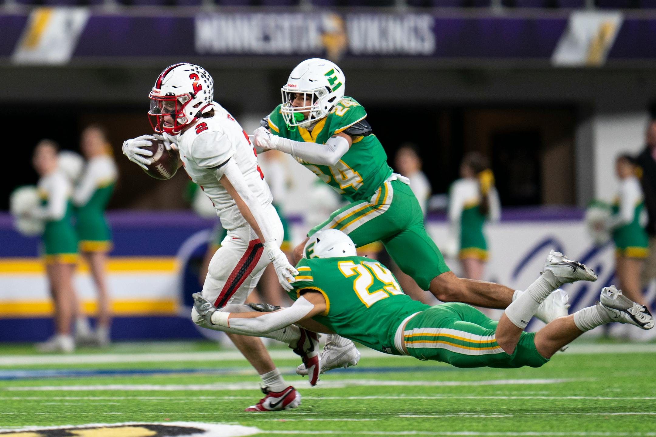 Edina High School cornerback Liam Holmberg (29) and Edina High School linebacker William Carlson (24) attempt to tackle Centennial High School wide receiver, offensive lineinebacker Ty Burgoon (2) as he makes away with the ball at the 6a game at U.S. Bank Stadium for the Prep Bowl XLI in Minneapolis on Friday, Nov. 24, 2023. ] Angelina Katsanis • angelina.katsanis@startribune.com
