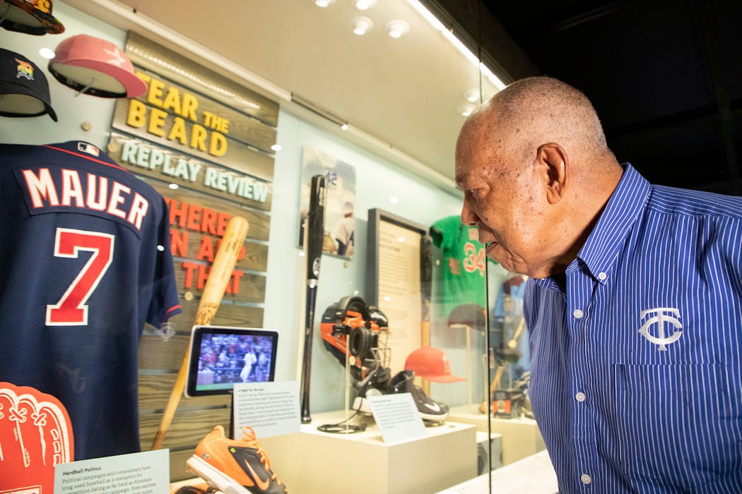 Tony Oliva examined a Hall of Fame exhibit containing a Joe Mauer jersey during his orientation visit in March 2022. 