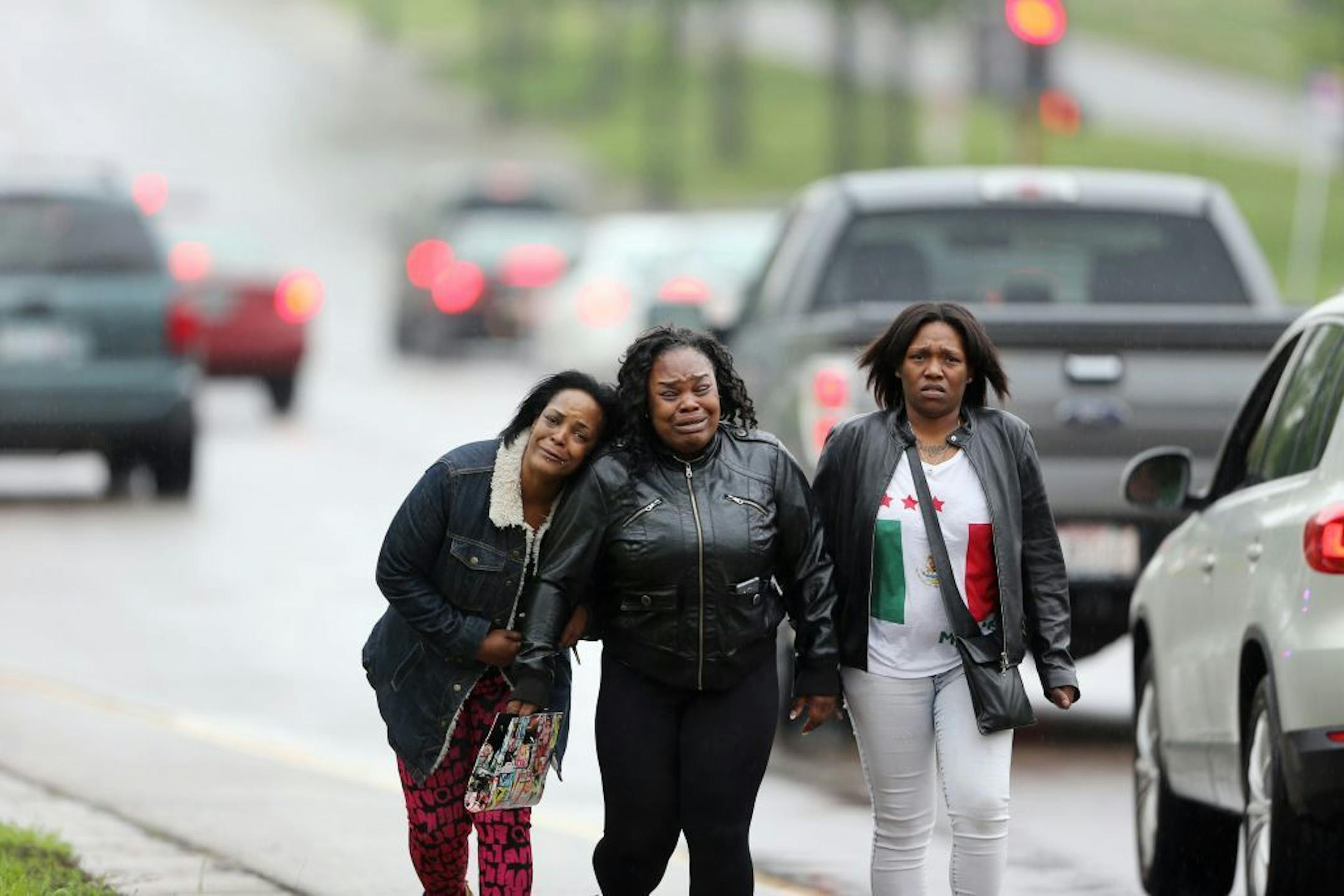 Family members and friends consoled each other as they walked along Olson Memorial High where a person was shot in killed Wednesday 11, 2016 in the 700 block of Oliver Avenue North Minneapolis, MN.