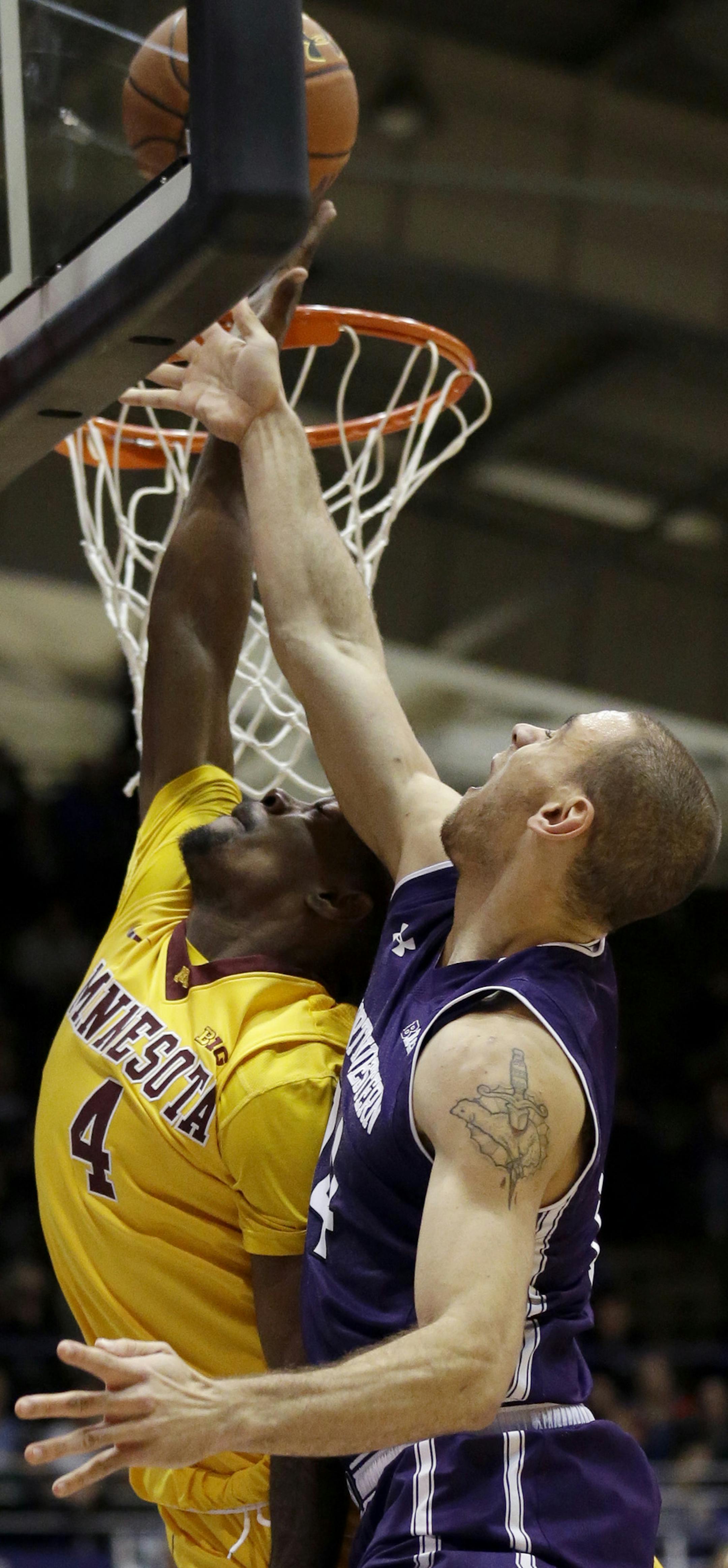 Northwestern guard Tre Demps, right, shoots over Minnesota guard Kevin Dorsey during the second half of an NCAA college basketball game on Thursday, Feb. 4, 2016, in Evanston, Ill. Northwestern won 82-58. (AP Photo/Nam Y. Huh)