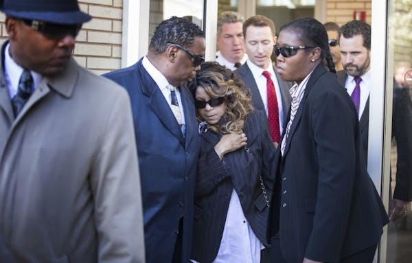 Prince's sister Tyka Nelson, center, leaves the Carver County Justice Center in Chaska with her husband Maurice Philips on Monday, May 2, 2016. With t