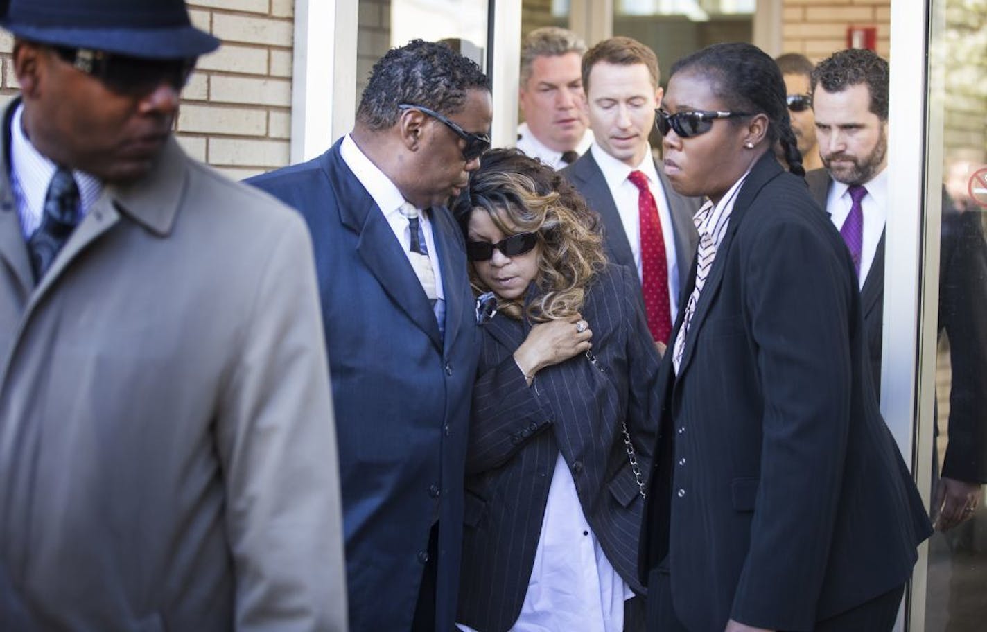 Prince's sister Tyka Nelson, center, leaves the Carver County Justice Center in Chaska with her husband Maurice Philips on Monday, May 2, 2016. With the approval of most of Prince's siblings, Carver County District Court Judge Kevin Eide confirmed the appointment of Bremer Trust, National Association as special administrator to manage the late musician's assets during a probate hearing.