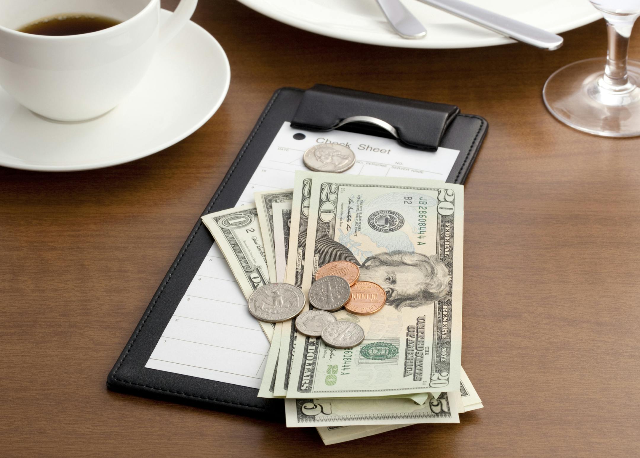 iStockphoto.com
Guest check with Cash and Coin on white background.