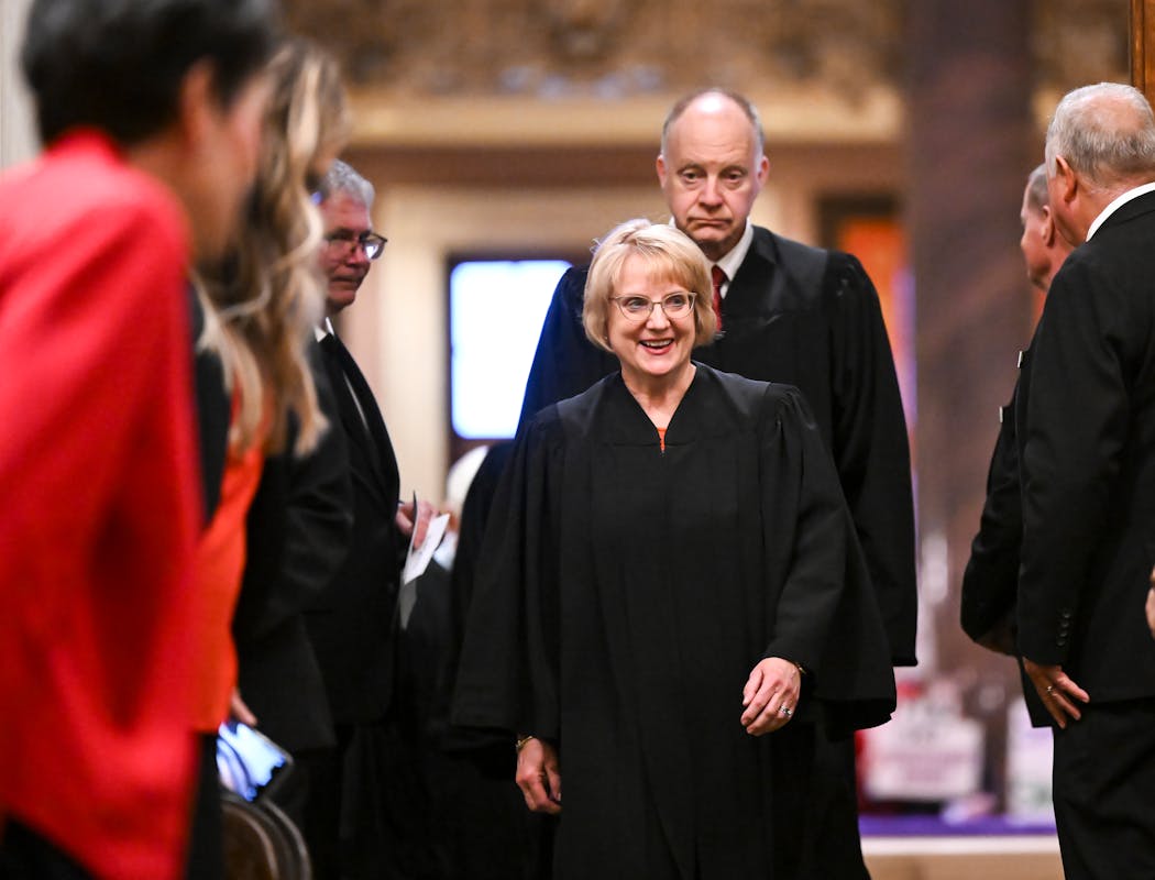 Minnesota Supreme Court Chief Justice Lorie Skjerven Gildea and Associate Justice Barry Anderson enter the House chambers before the State of the State address Wednesday, April 19, 2023.